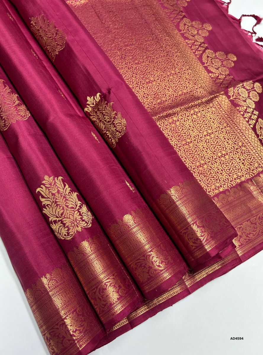 The Aesthetic Maroon Kanchi Border Soft Silk Saree with Pure Gold Zari is a majestic handwoven creation that radiates regal charm and cultural richness, making it ideal for weddings, temple ceremonies, and festive occasions.