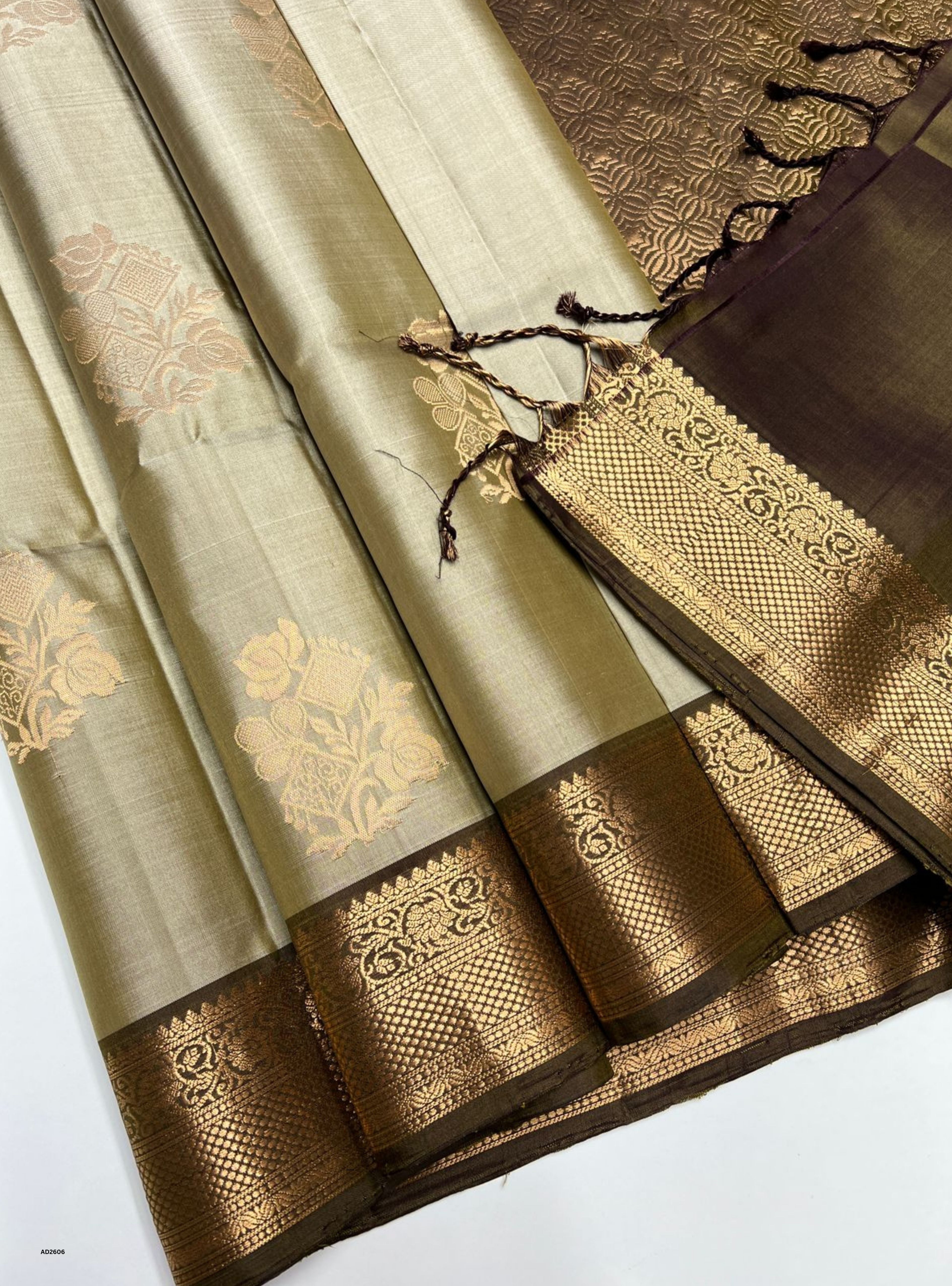 Saree with intricate gold patterns on a white background