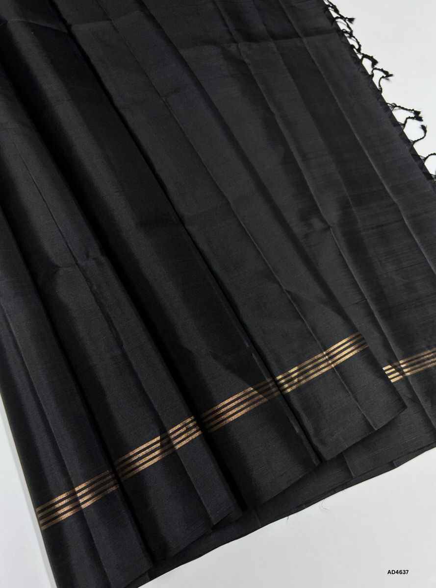 The Black Plain Soft Silk Saree with Pure Gold Zari is a timeless handwoven creation that radiates regal charm and cultural elegance, making it ideal for weddings, temple ceremonies, and festive occasions.