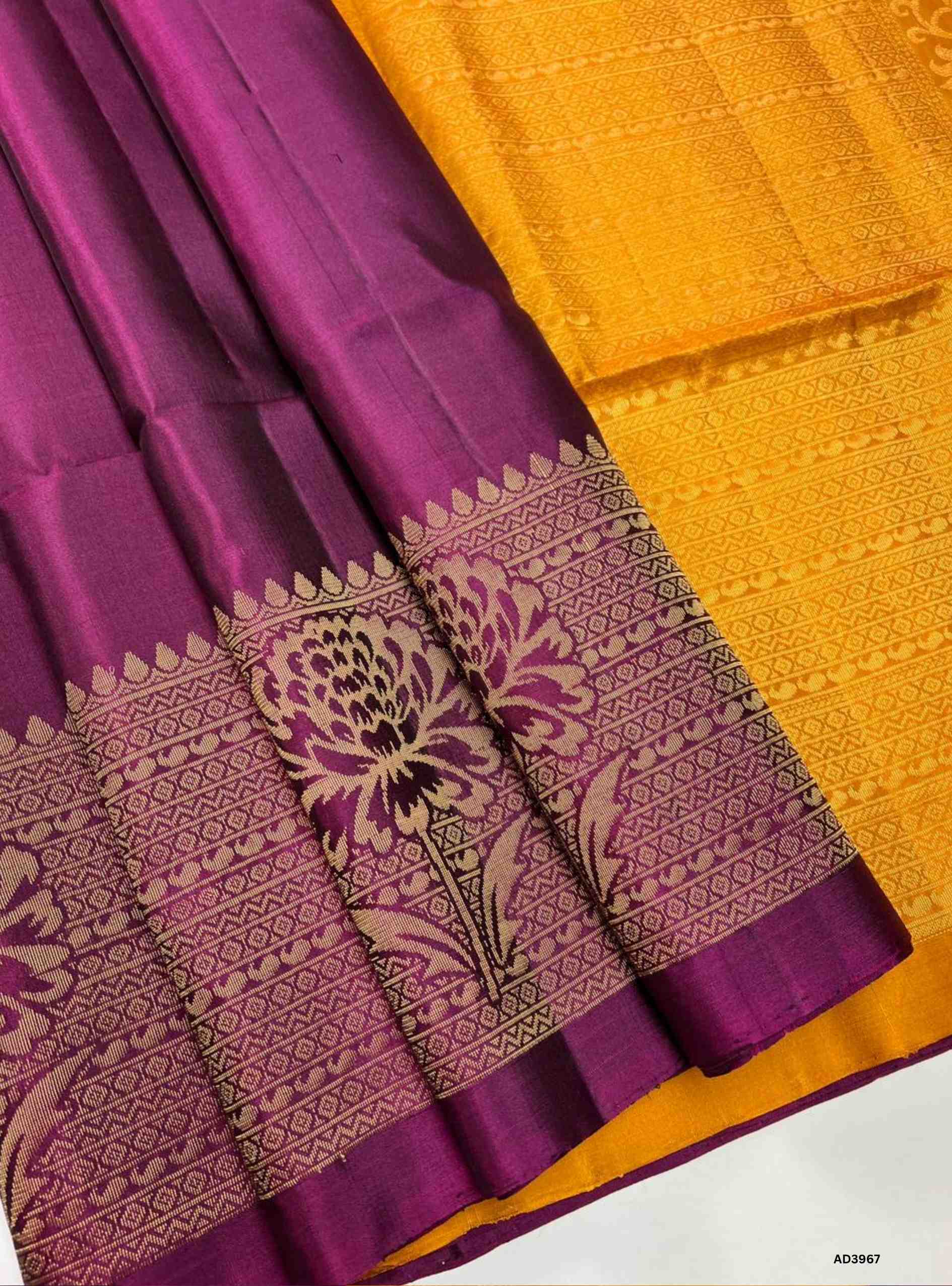 The Burgundy & Mango Yellow Turning Border Soft Silk Saree is a radiant handwoven masterpiece that celebrates festive grandeur with heritage weaving. The deep burgundy shade radiates regal elegance, while the mango yellow adds auspicious brilliance and warmth. The turning border, woven with pure gold zari and traditional motifs, enhances the saree’s grandeur, making it ideal for weddings, temple ceremonies, and cultural gatherings. With its lustrous drape and shimmering pallu, this saree embodies South Indi