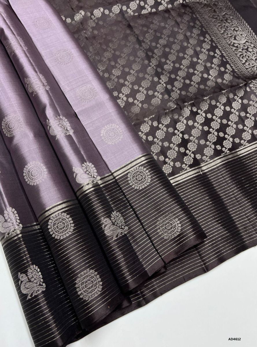 The Coco Grey & Coffee Brown Bhutta Soft Silk Saree with Pure Gold Zari is a graceful handwoven creation that unites subtle elegance with earthy richness, making it perfect for weddings, festive occasions, and temple ceremonies.