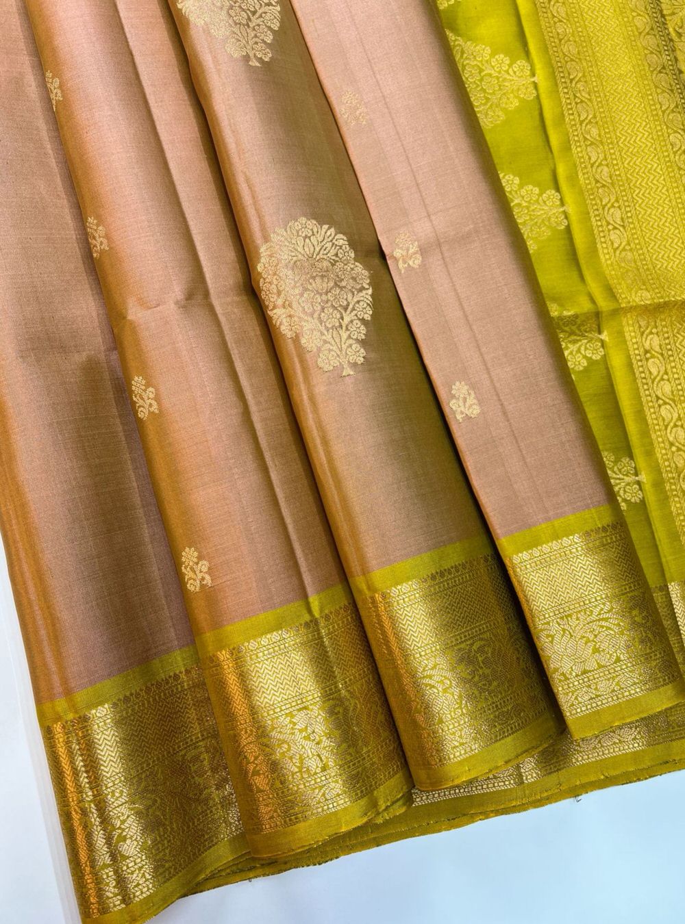 "Handwoven Dusky Peach body with Chartreuse pallu Bhutta Soft Silk Saree featuring gold zari motifs and borders"