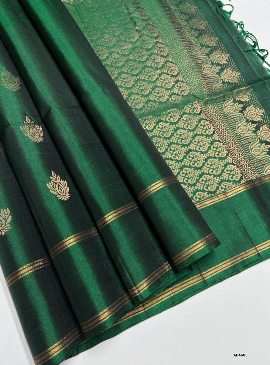 The Green Bhutta Soft Silk Saree with Pure Gold Zari is a radiant handwoven creation that symbolizes prosperity and devotion, enriched with intricate bhutta motifs, making it ideal for weddings, temple ceremonies, and festive occasions.