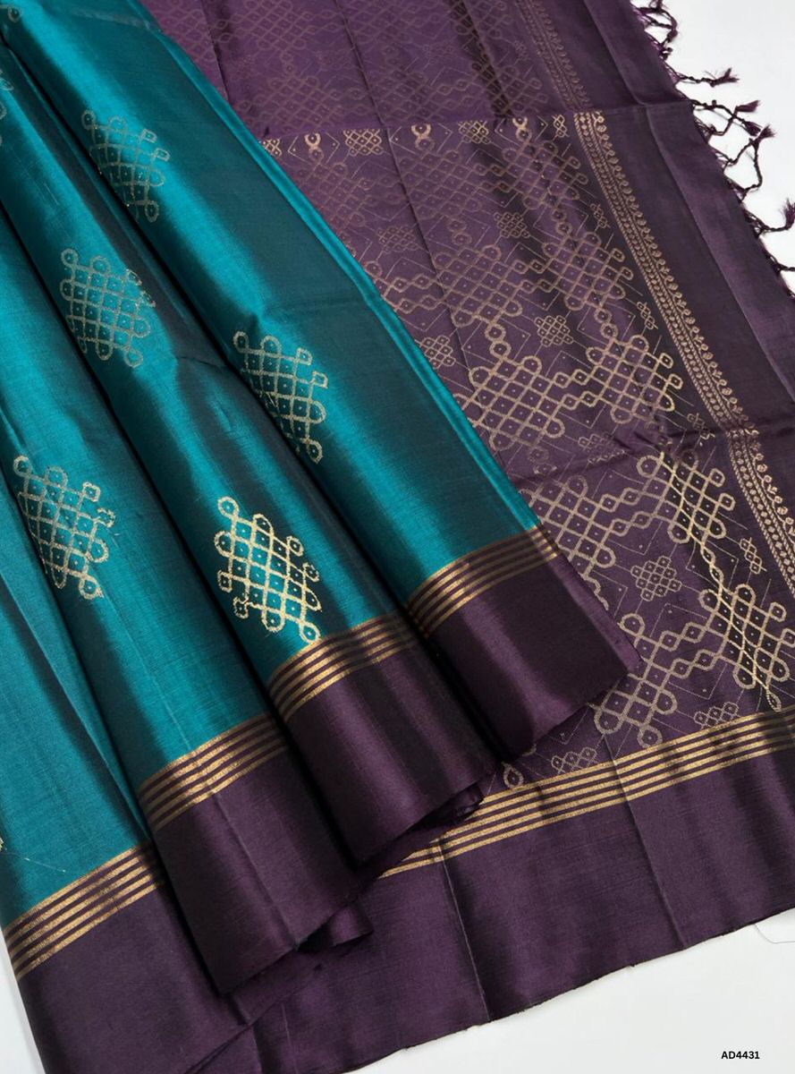 The Green & Coffee Brown Kolam Soft Silk Saree with Pure Gold Zari is a refined handwoven creation that unites festive vibrance with earthy elegance, making it ideal for weddings, temple ceremonies, and cultural occasions.
