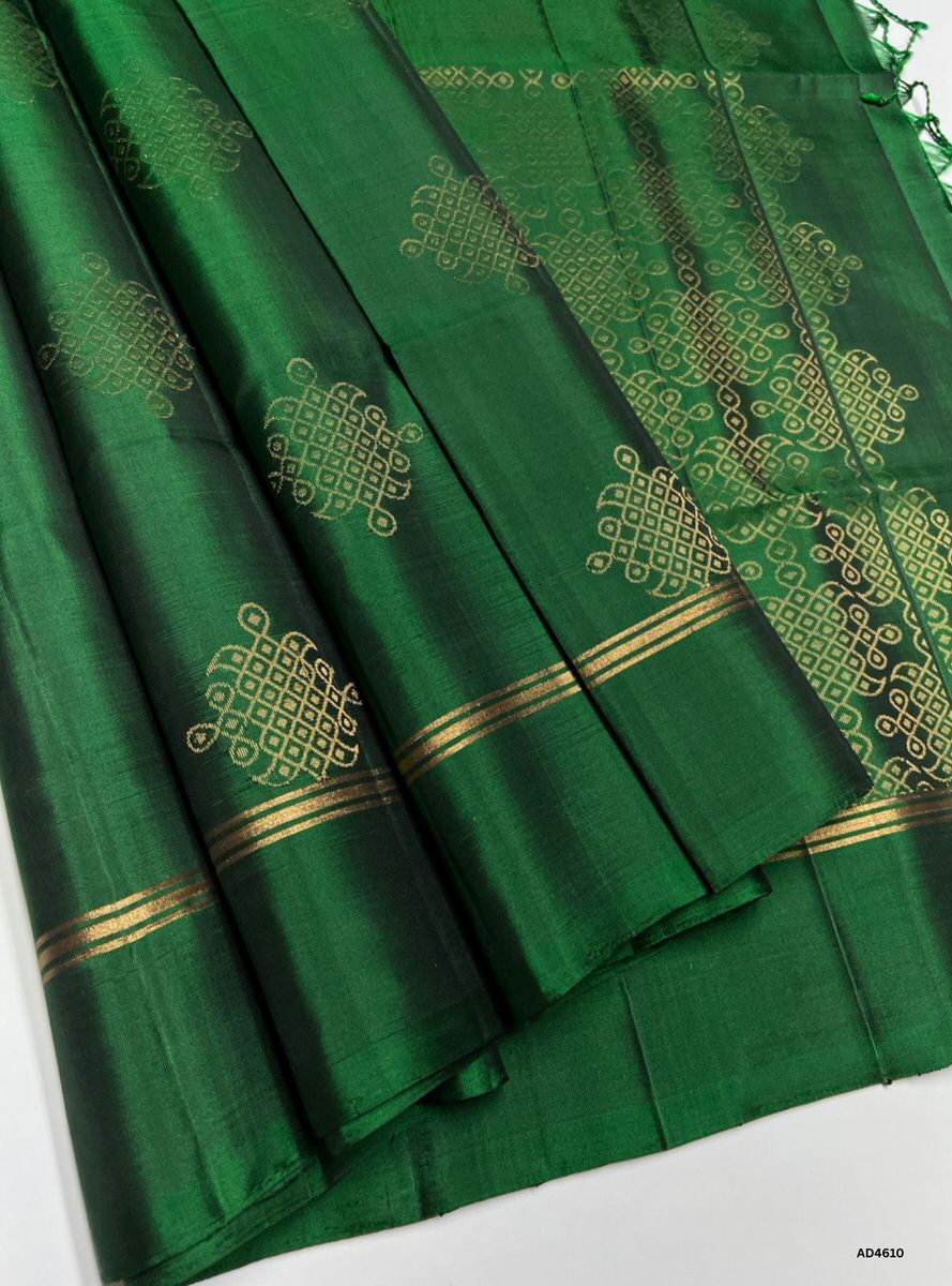 The Green Kolam Soft Silk Saree with Pure Gold Zari is a timeless handwoven creation that radiates auspicious charm and cultural richness, making it ideal for weddings, temple ceremonies, and festive occasions.
