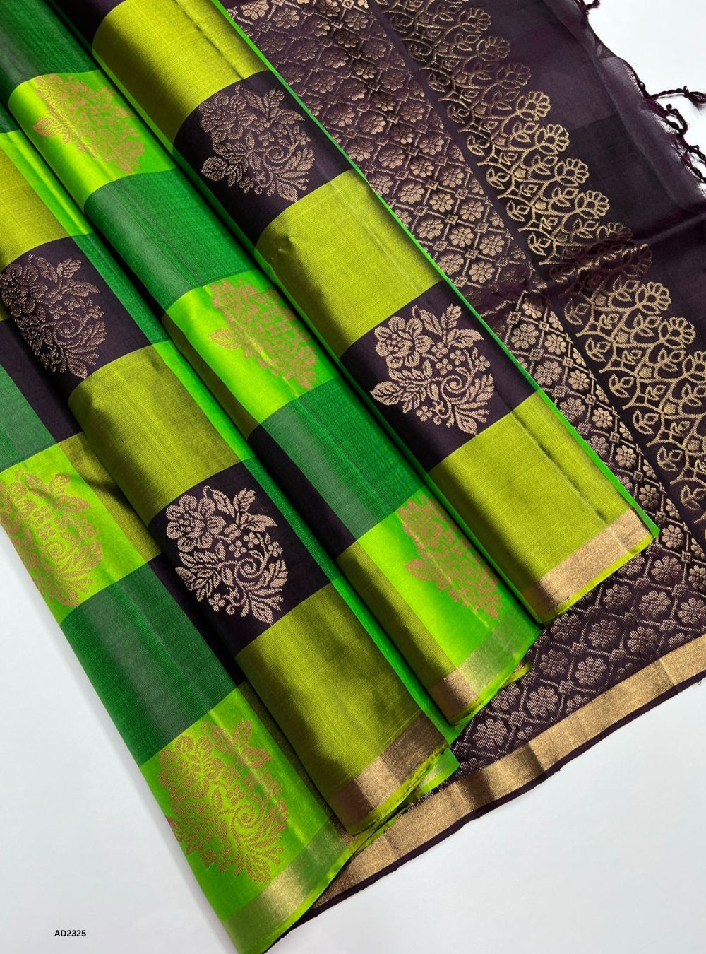 Green and black saree with floral patterns on a white background