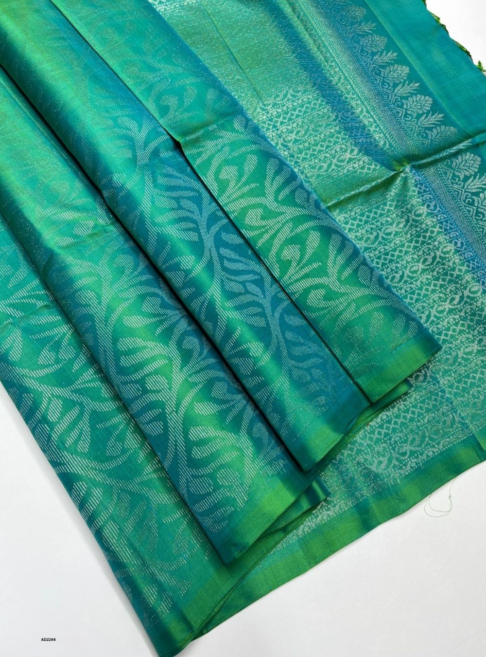 Green and blue patterned fabric on a white background