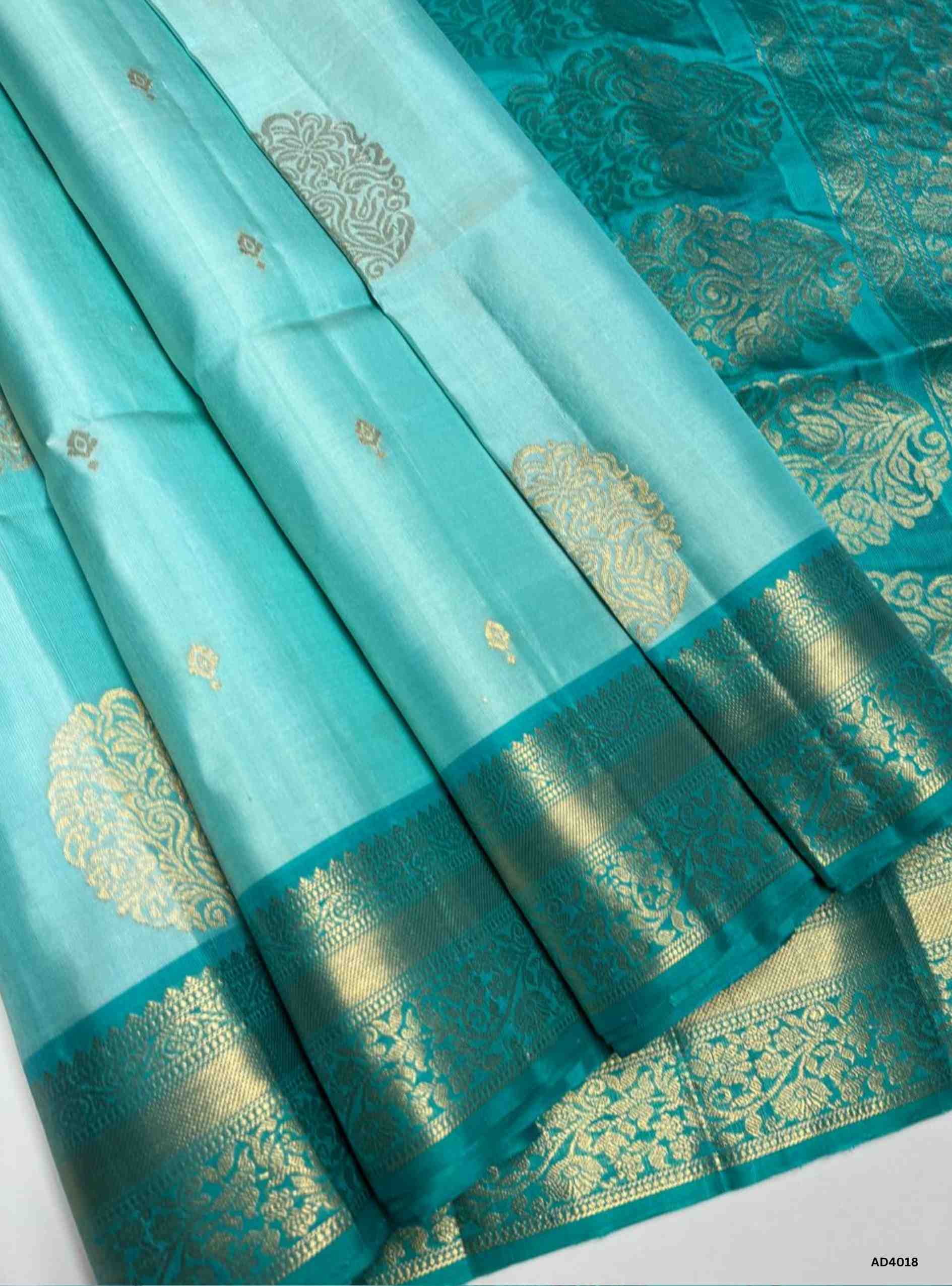 The Ice Blue & Rama Blue Kanchi Border Soft Silk Saree is a heritage handwoven masterpiece that radiates elegance and festive brilliance. The soothing ice blue shade symbolizes serenity and grace, while the vibrant rama blue adds depth, prosperity, and auspiciousness. The grand Kanchi border, adorned with temple‑inspired motifs in pure gold zari, elevates its heritage appeal. The shimmering pallu completes the ensemble, making it perfect for weddings, temple ceremonies, and cultural celebrations. This saree