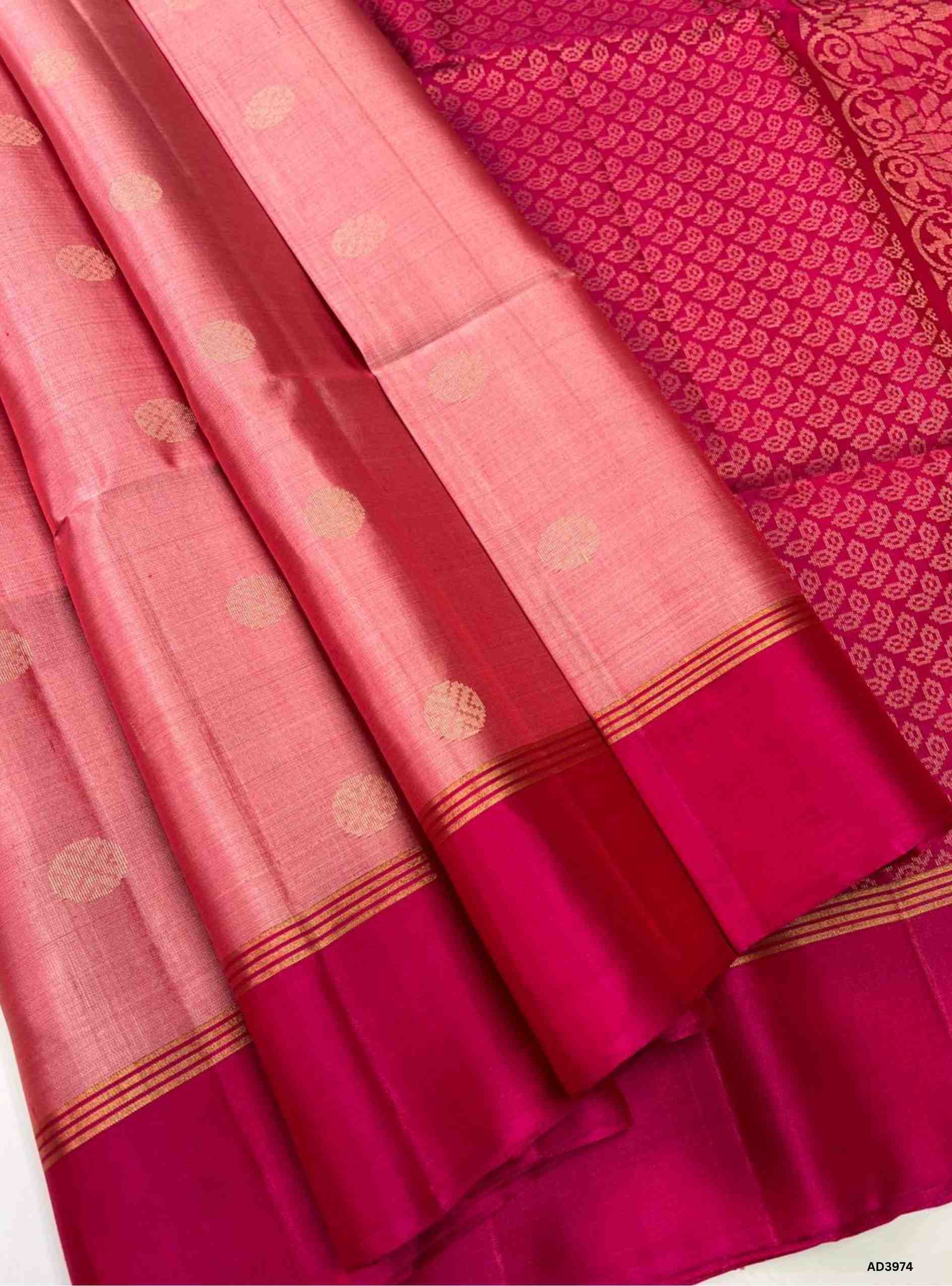 The Light Pink & Rani Pink Bhutta Soft Silk Saree is a graceful handwoven creation that celebrates feminine elegance with festive grandeur. The soothing light pink shade radiates subtle charm and delicacy, while the vibrant rani pink adds richness and celebratory brilliance. The bhutta weave, adorned with intricate motifs, enhances the saree’s artistry, while zari highlights on the border and pallu lend a shimmering appeal. Perfect for weddings, temple ceremonies, and cultural gatherings, this saree embodie