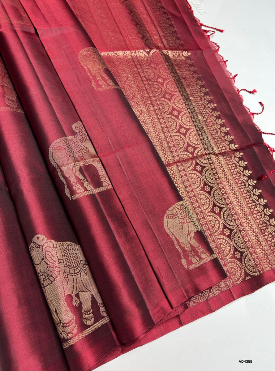 The Maroon Fancy Soft Silk Saree is a majestic handwoven creation that radiates cultural richness and festive grandeur. The regal maroon shade symbolizes devotion, prosperity, and heritage depth, while the fancy motifs add ornamental artistry and intricate detailing. Enhanced with pure gold zari borders and a lustrous drape, this saree is perfect for weddings, temple ceremonies, and celebratory occasions. A timeless masterpiece, it blends jewel‑tone vibrance with motif‑centric weaving heritage.