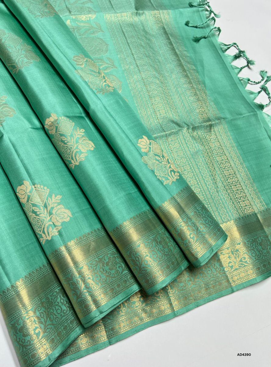 The Mint Green Kanchi Border Soft Silk Saree is a graceful handwoven creation that radiates cultural richness and festive charm. The mint green shade conveys freshness, prosperity, and celebratory elegance, while the temple‑inspired Kanchi border enriched with pure gold zari elevates its grandeur. With its lustrous drape and coordinated blouse, this saree is perfect for weddings, temple ceremonies, and festive occasions. A timeless masterpiece, it blends pastel vibrance with the heritage of Kanchipuram weav