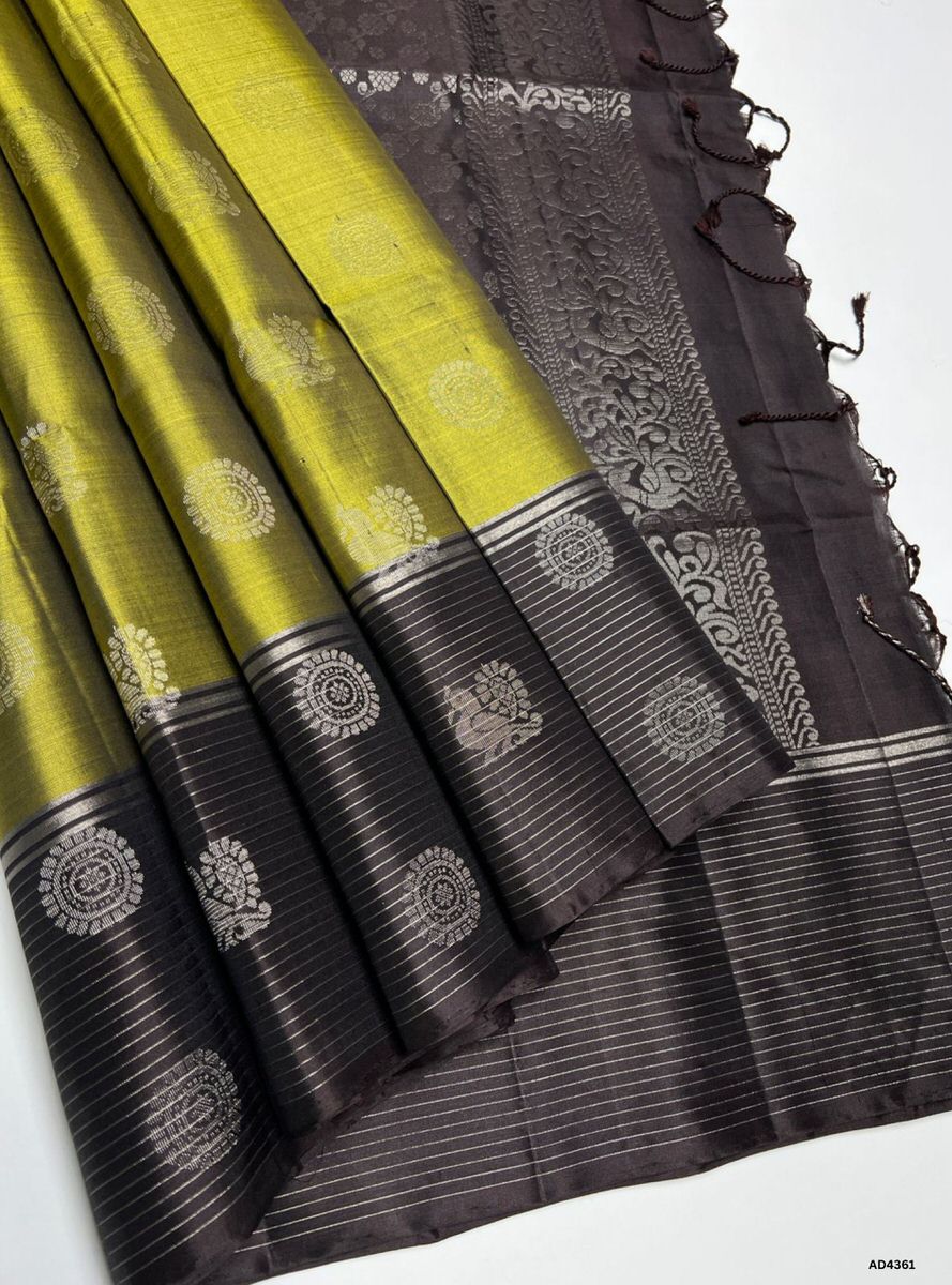 The Olive Green & Coffee Brown Soft Silk Saree is a graceful handwoven creation that radiates cultural richness and festive charm. The olive green shade symbolizes harmony, prosperity, and heritage elegance, while the coffee brown contrast conveys warmth, devotion, and earthy sophistication. Enhanced with pure gold zari borders and a lustrous drape, this saree is perfect for weddings, temple ceremonies, and celebratory occasions. A timeless masterpiece, it blends nature‑inspired tones with South Indian weav