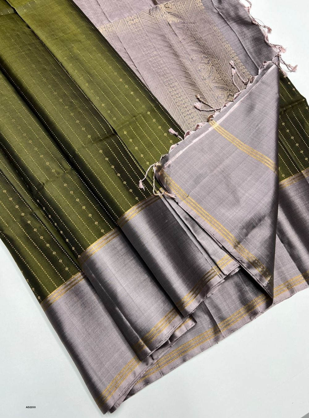 Gray and green saree with a pattern on a white background