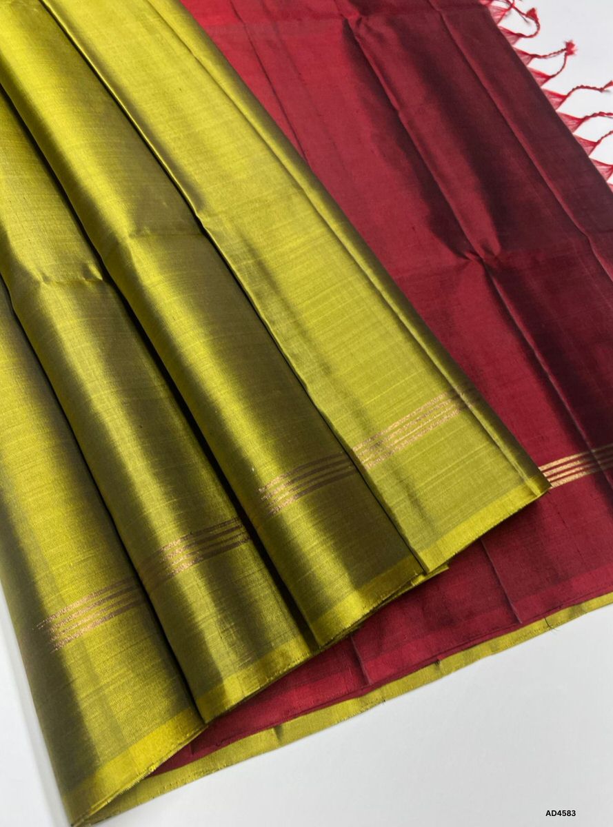 The Olive Green & Maroon Plain Soft Silk Saree with Pure Gold Zari is a timeless handwoven creation that unites earthy sophistication with festive richness, making it ideal for weddings, temple ceremonies, and cultural occasions.