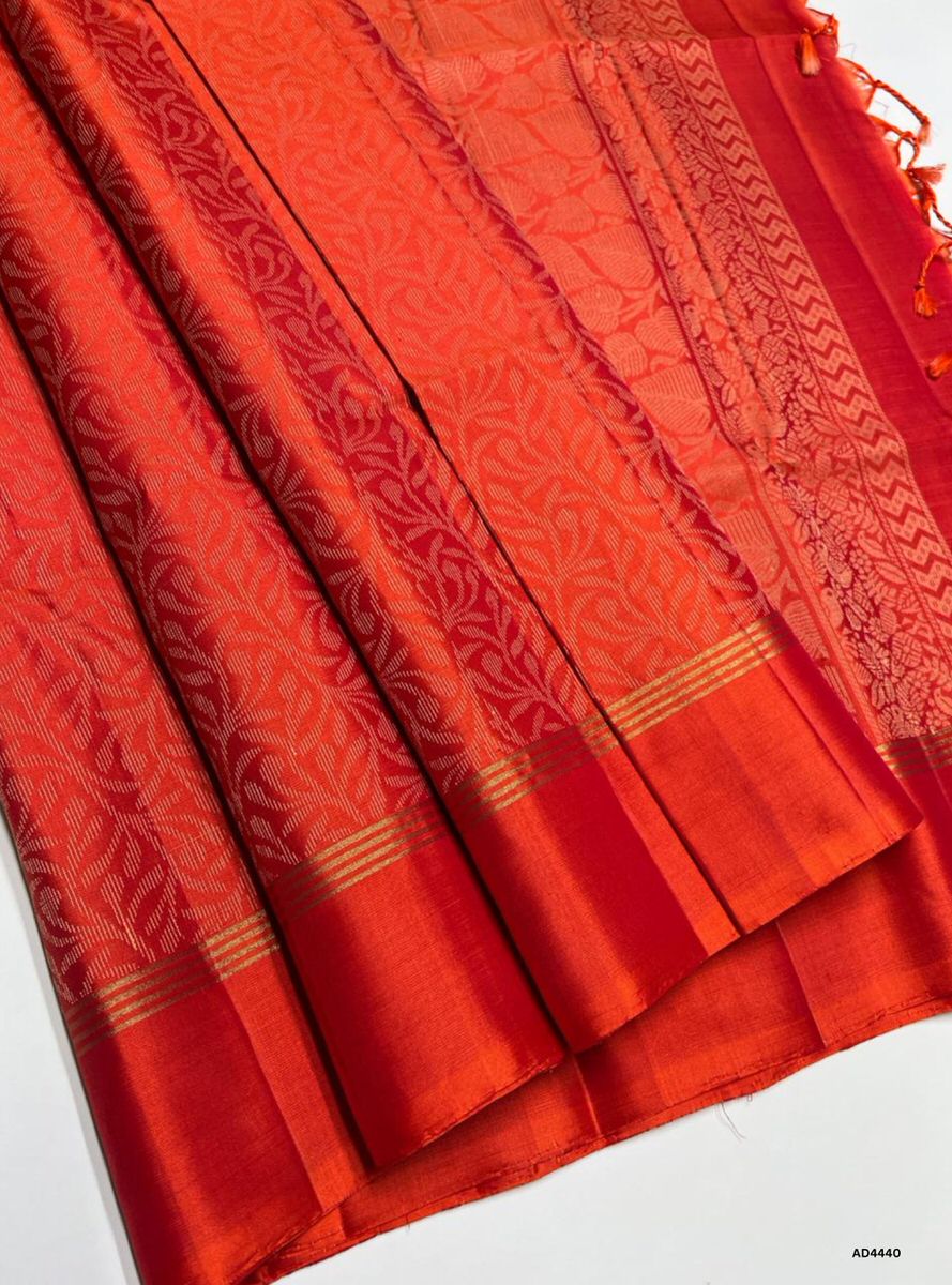 The Orange Soft Silk Bridal Saree with Half Fine Tested Gold Zari is a radiant handwoven creation that symbolizes prosperity, energy, and celebration, making it ideal for weddings, receptions, and auspicious occasions.