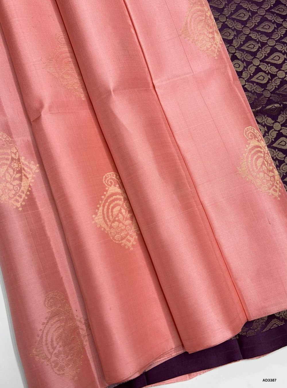 "Handwoven Peach Pink body with Burgundy pallu Bhutta Soft Silk Saree featuring gold zari motifs and borders"