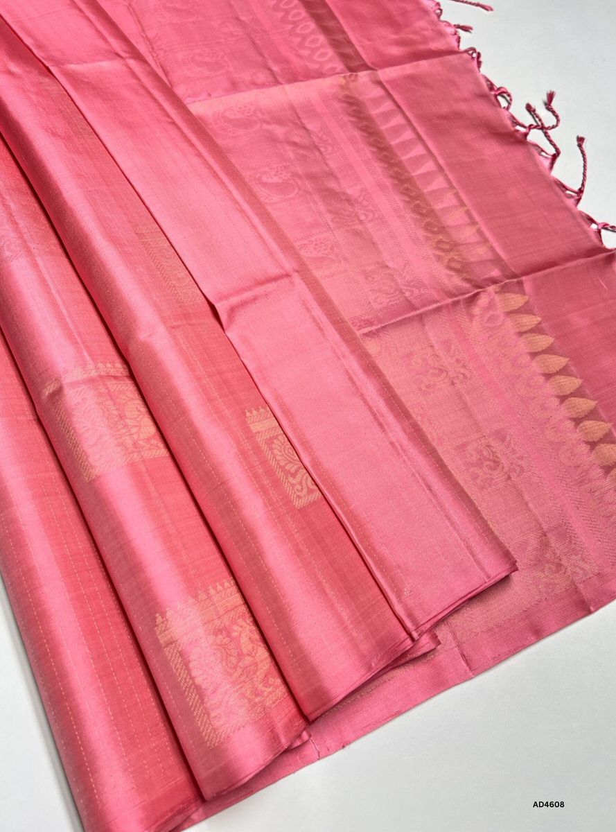 The Peachish Pink Bhutta Soft Silk Saree with Pure Gold Zari is a graceful handwoven creation that radiates pastel elegance and cultural richness, making it perfect for weddings, temple ceremonies, and festive occasions.