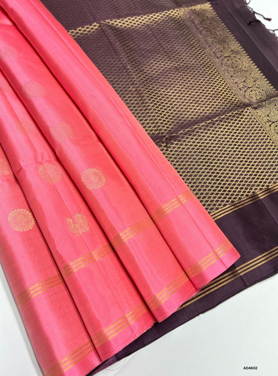 The Pink & Coffee Brown Bhutta Soft Silk Saree with Pure Gold Zari is a refined handwoven creation that unites feminine elegance with earthy richness, enriched by intricate bhutta motifs, making it ideal for weddings, temple ceremonies, and festive occasions.