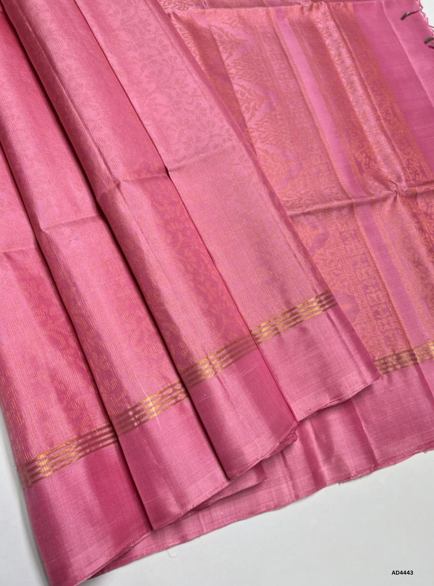 The Pink Soft Silk Bridal Saree with Half Fine Tested Gold Zari is a graceful handwoven creation that radiates youthful elegance and festive charm, making it ideal for weddings, receptions, and temple ceremonies.