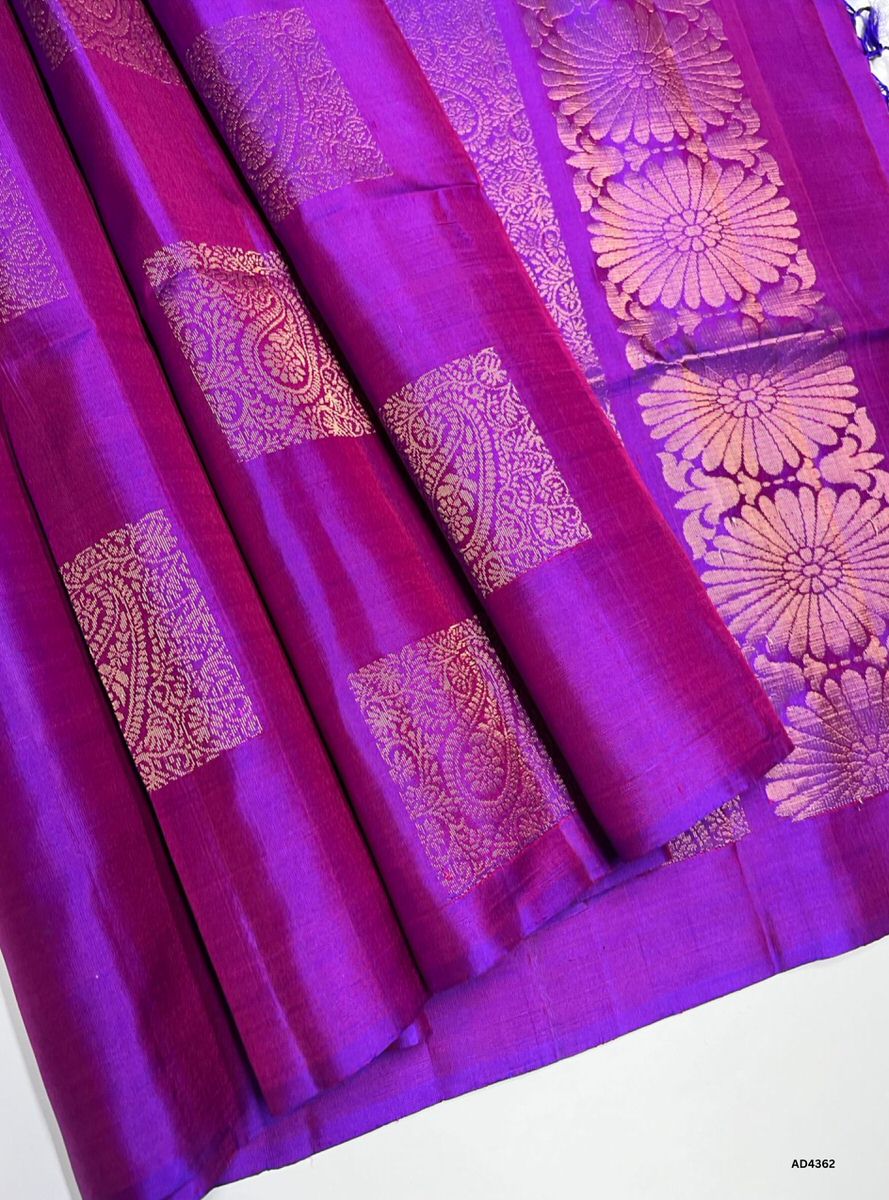 The Pinkish Purple Bhutta Soft Silk Saree is a radiant handwoven creation that embodies festive charm and cultural richness. The pinkish purple shade conveys devotion, elegance, and celebratory vibrance, while the bhutta motifs scattered across the body add ornamental artistry and heritage depth. Enhanced with pure gold zari borders and a lustrous drape, this saree is perfect for weddings, temple ceremonies, and festive occasions. A timeless masterpiece, it blends jewel‑tone brilliance with motif‑centric we