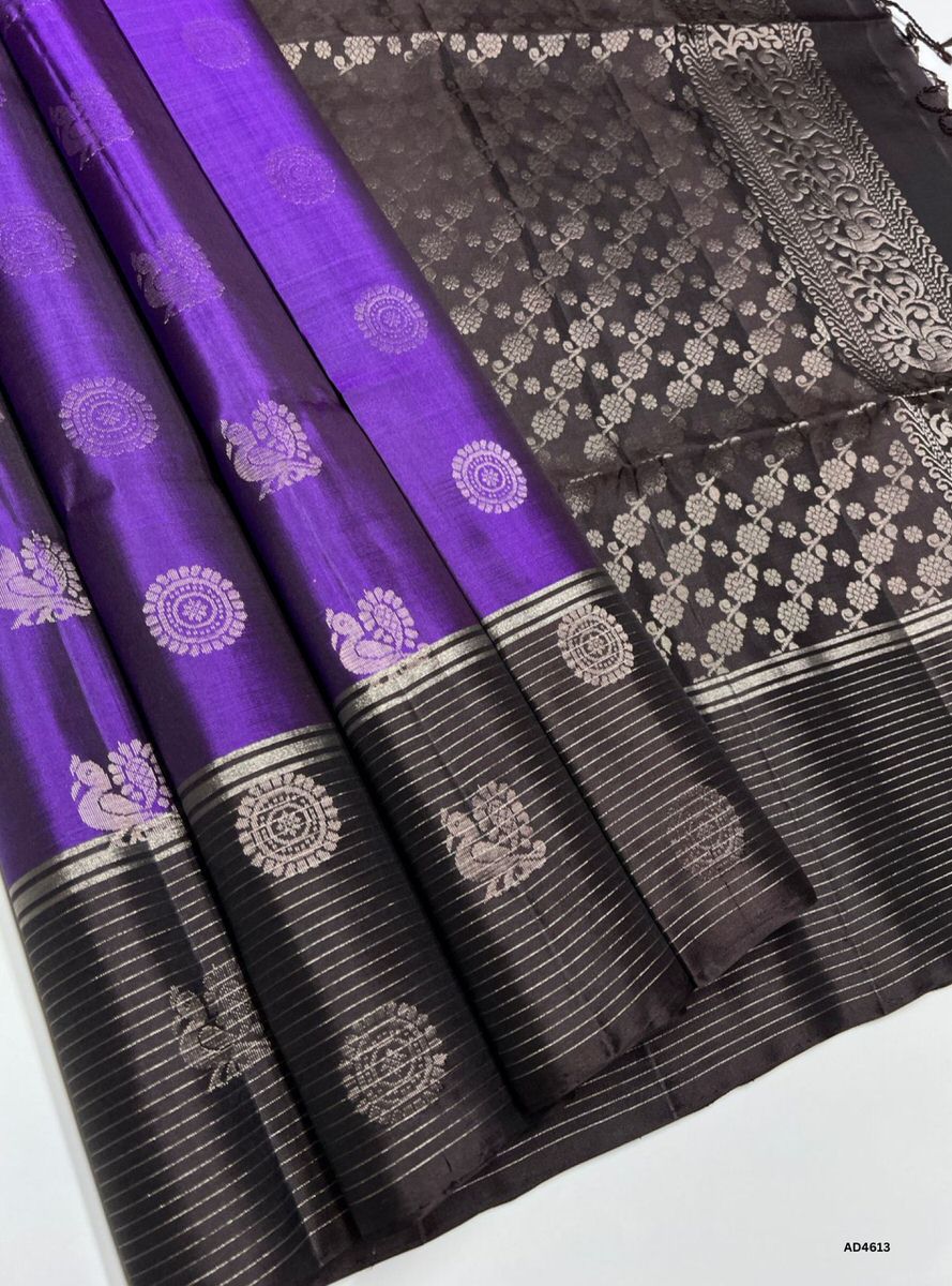 The Purple & Coffee Brown Bhutta Soft Silk Saree with Pure Gold Zari is a majestic handwoven creation that unites regal vibrance with earthy richness, making it perfect for weddings, temple ceremonies, and festive occasions.