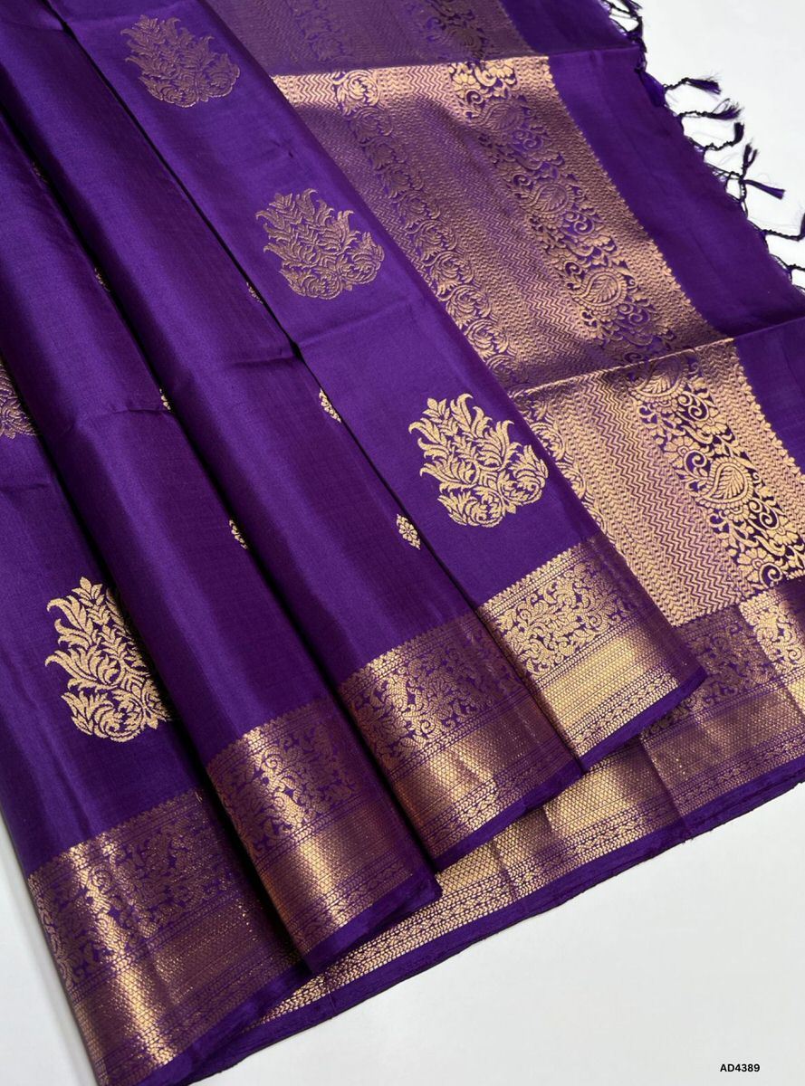 The Purple Kanchi Border Soft Silk Saree is a majestic handwoven creation that radiates cultural richness and festive elegance. The regal purple shade symbolizes devotion, prosperity, and timeless sophistication, while the traditional Kanchi border enriched with pure gold zari elevates its grandeur. With its lustrous drape and coordinated blouse, this saree is perfect for weddings, temple ceremonies, and cultural gatherings. A timeless piece of artistry, it blends jewel‑tone vibrance with the heritage of Ka