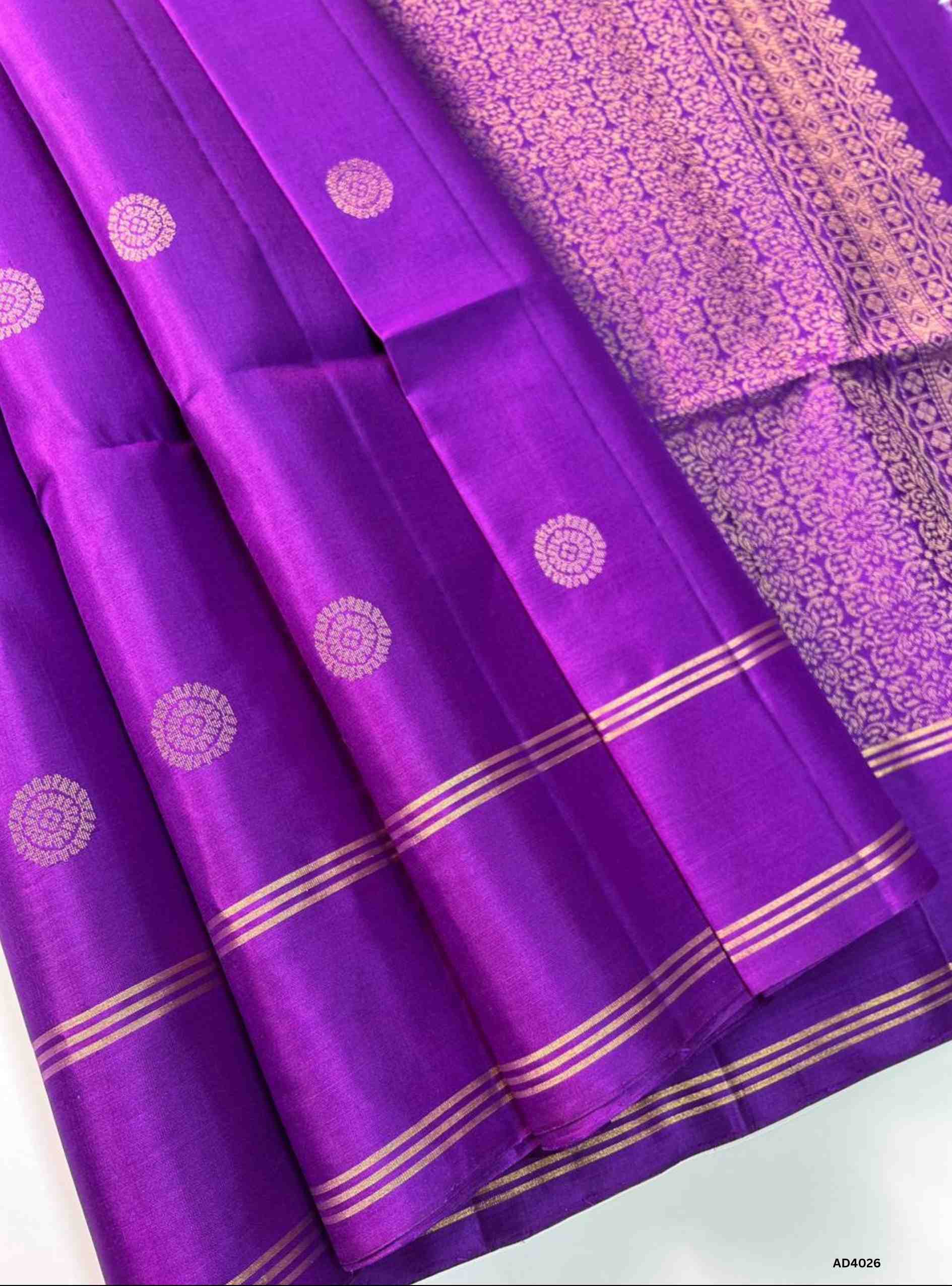 The Purple Bhutta Soft Silk Saree is a majestic handwoven creation that radiates festive brilliance and cultural richness. The deep purple shade symbolizes royalty, prosperity, and timeless elegance. The bhutta weave, adorned with intricate motifs, adds depth and artistry, while zari highlights on the border and pallu lend a shimmering finish. Perfect for weddings, temple ceremonies, and cultural gatherings, this saree embodies South Indian craftsmanship with a jewel‑tone palette.