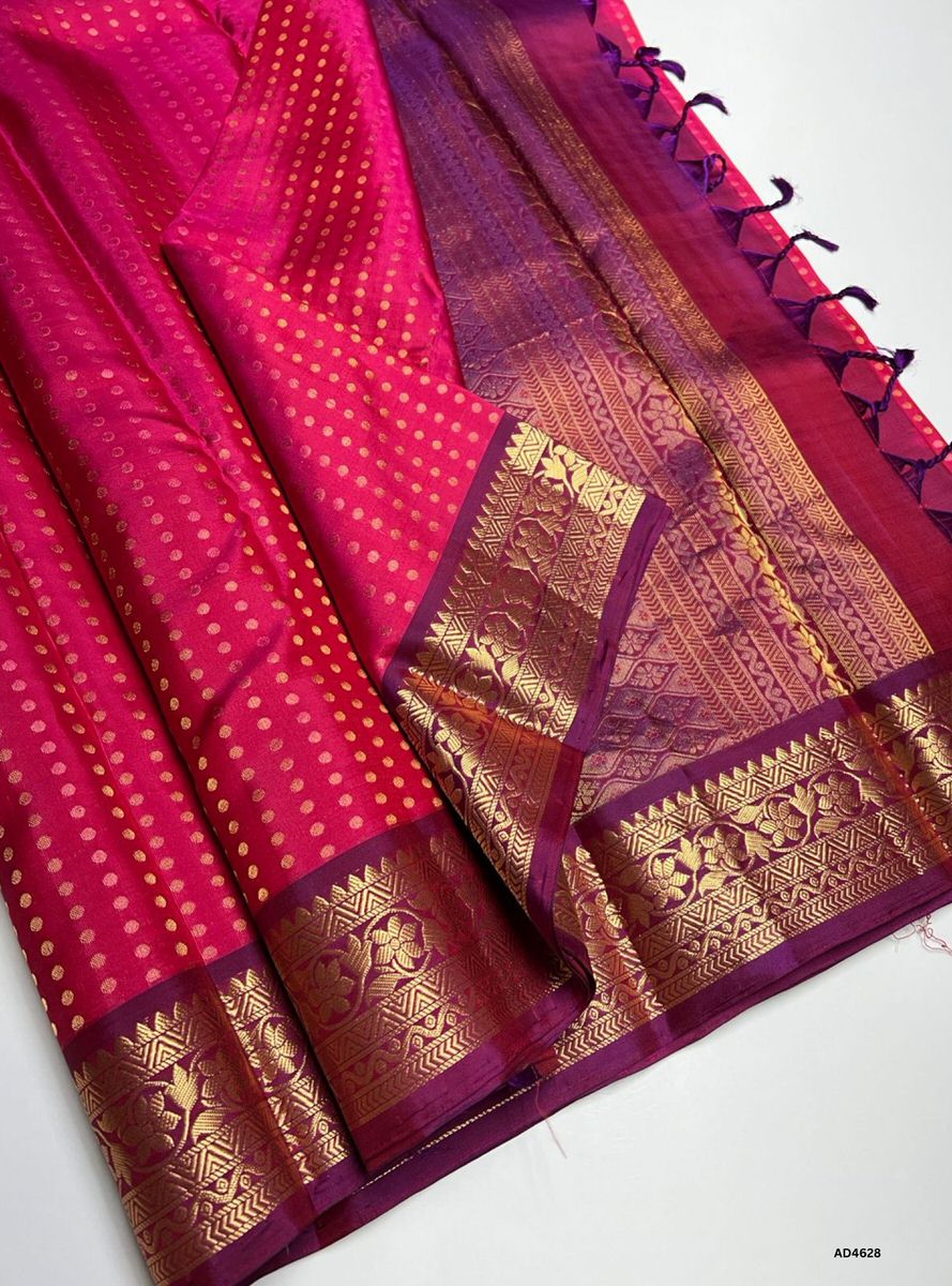 The Rani Pink & Purple Kanchi Border Soft Silk Saree with 1000 Bhutta and Half Fine Tested Gold Zari is a radiant handwoven creation that unites festive vibrance with regal depth, making it perfect for weddings, temple ceremonies, and cultural celebrations.
