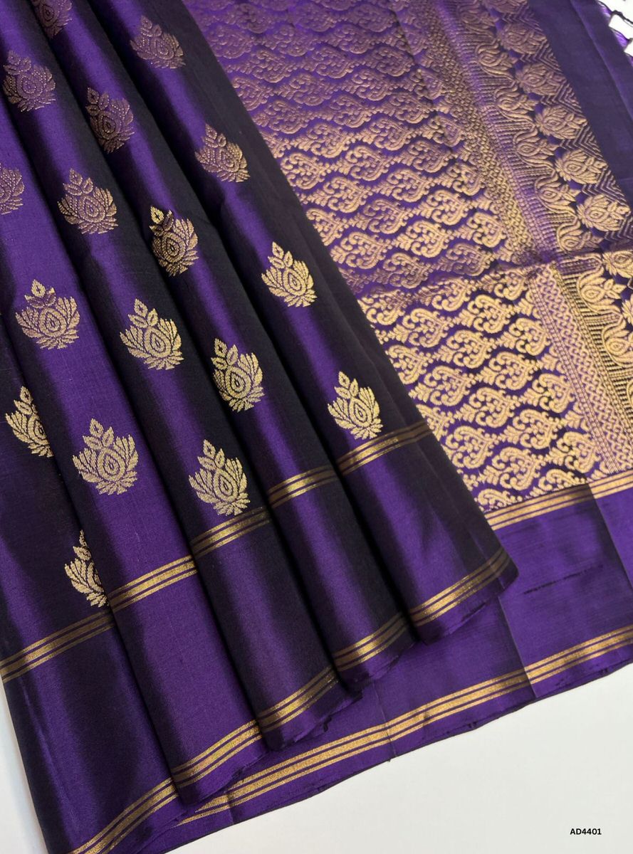 The Royal Purple Soft Silk Saree with Bhutta motifs is a majestic handwoven creation that radiates elegance, prosperity, and cultural richness. The deep royal purple shade symbolizes grandeur and devotion, while the bhutta motifs woven across the body add heritage artistry and festive charm. Enhanced with pure gold zari borders and a lustrous drape, this saree is ideal for weddings, temple ceremonies, and auspicious occasions. Its regal palette pairs beautifully with traditional jewelry, ensuring the wearer