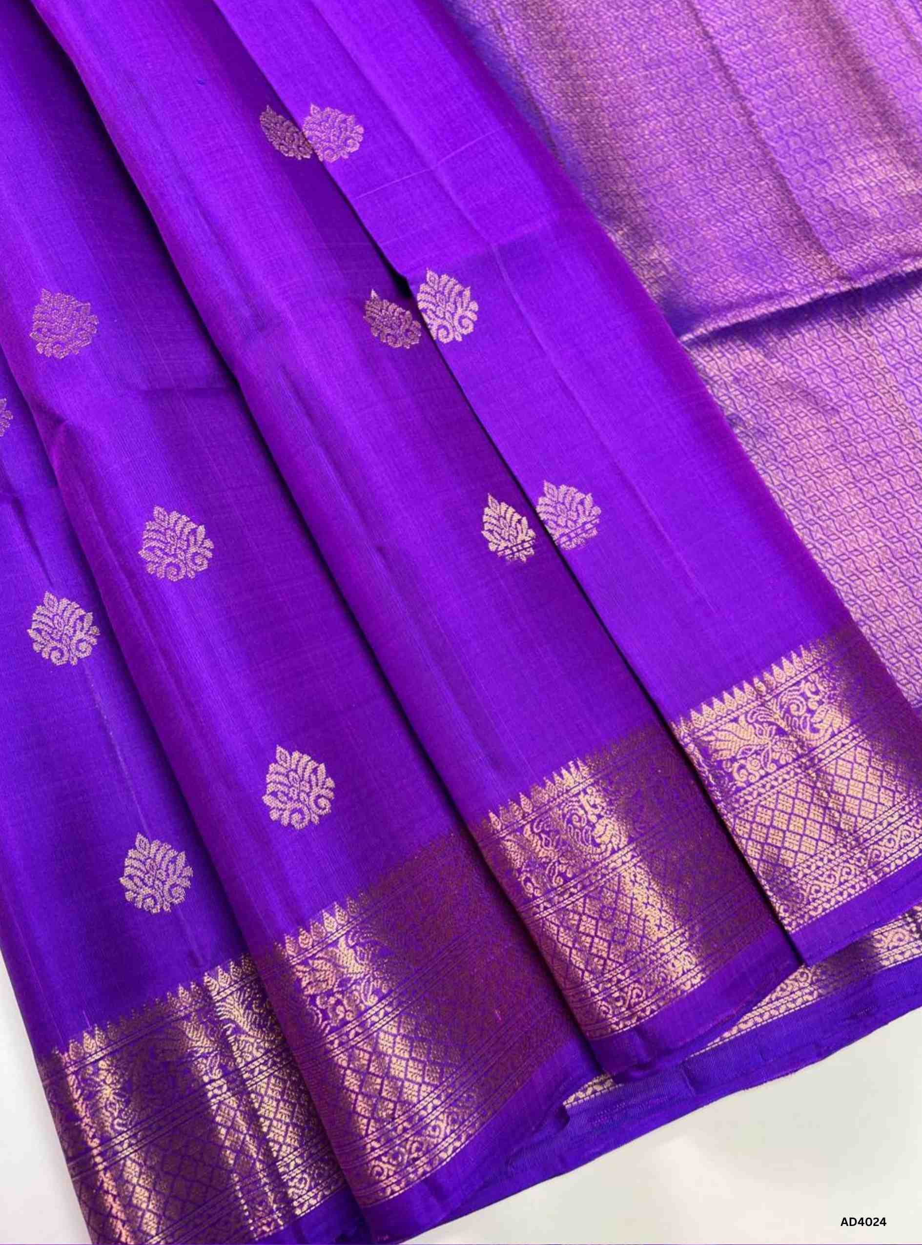 The Royal Purple Kanchi Border Soft Silk Saree is a regal handwoven creation that radiates festive brilliance and cultural richness. The deep royal purple shade symbolizes majesty, prosperity, and timeless elegance, while the grand Kanchi border, adorned with temple‑inspired motifs in pure gold zari, elevates its heritage appeal. The shimmering pallu completes the ensemble, making it perfect for weddings, temple ceremonies, and cultural celebrations. This saree embodies South Indian craftsmanship with a jew