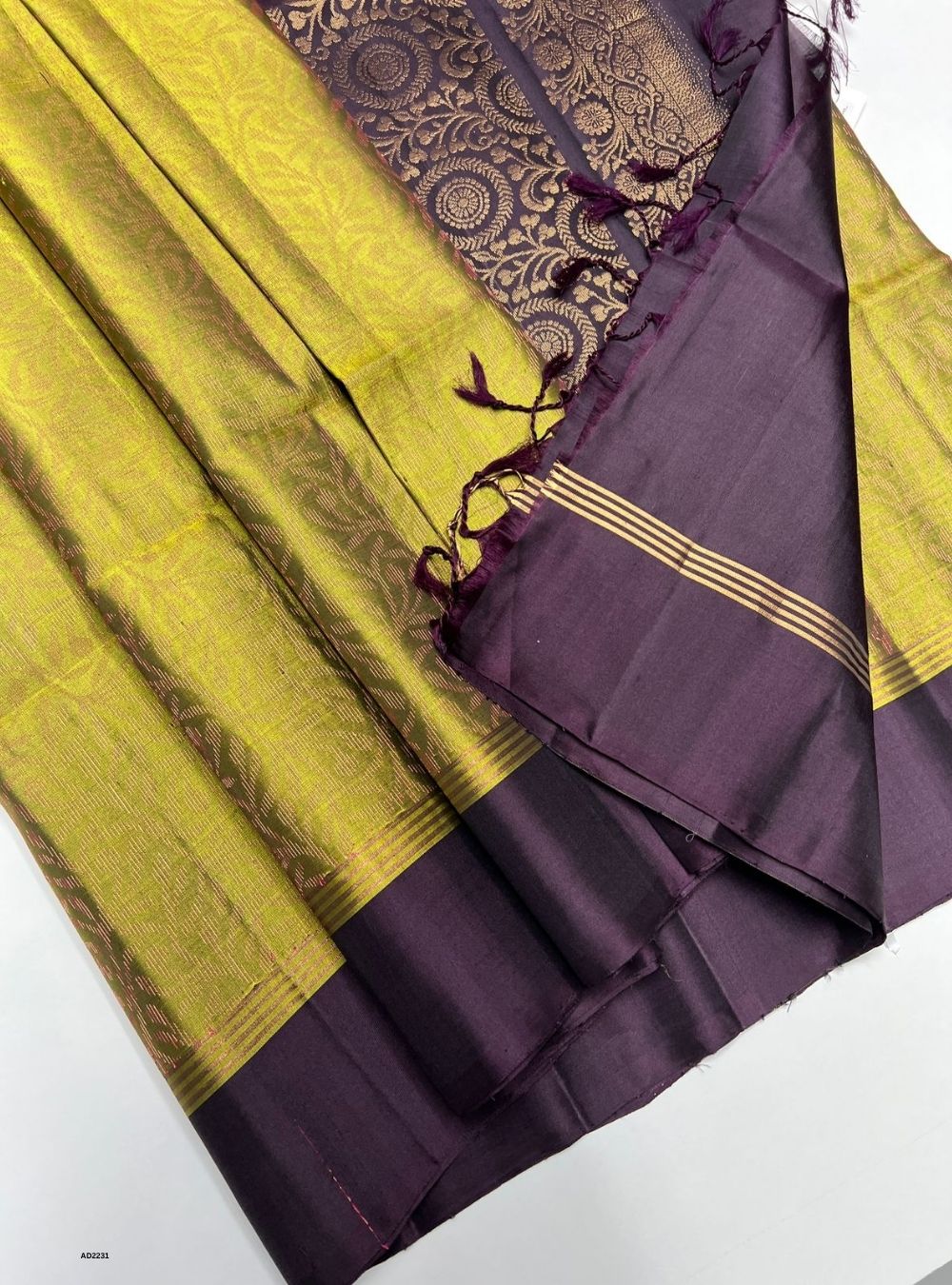 Saree with purple and yellow pattern on a white background