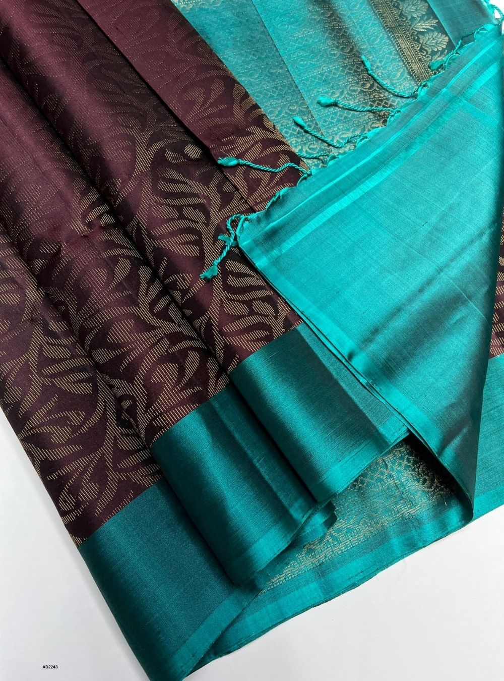 Teal and brown fabric with a pattern on a white background