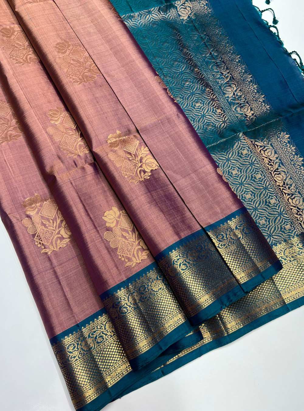 Two sarees with intricate patterns on a white background