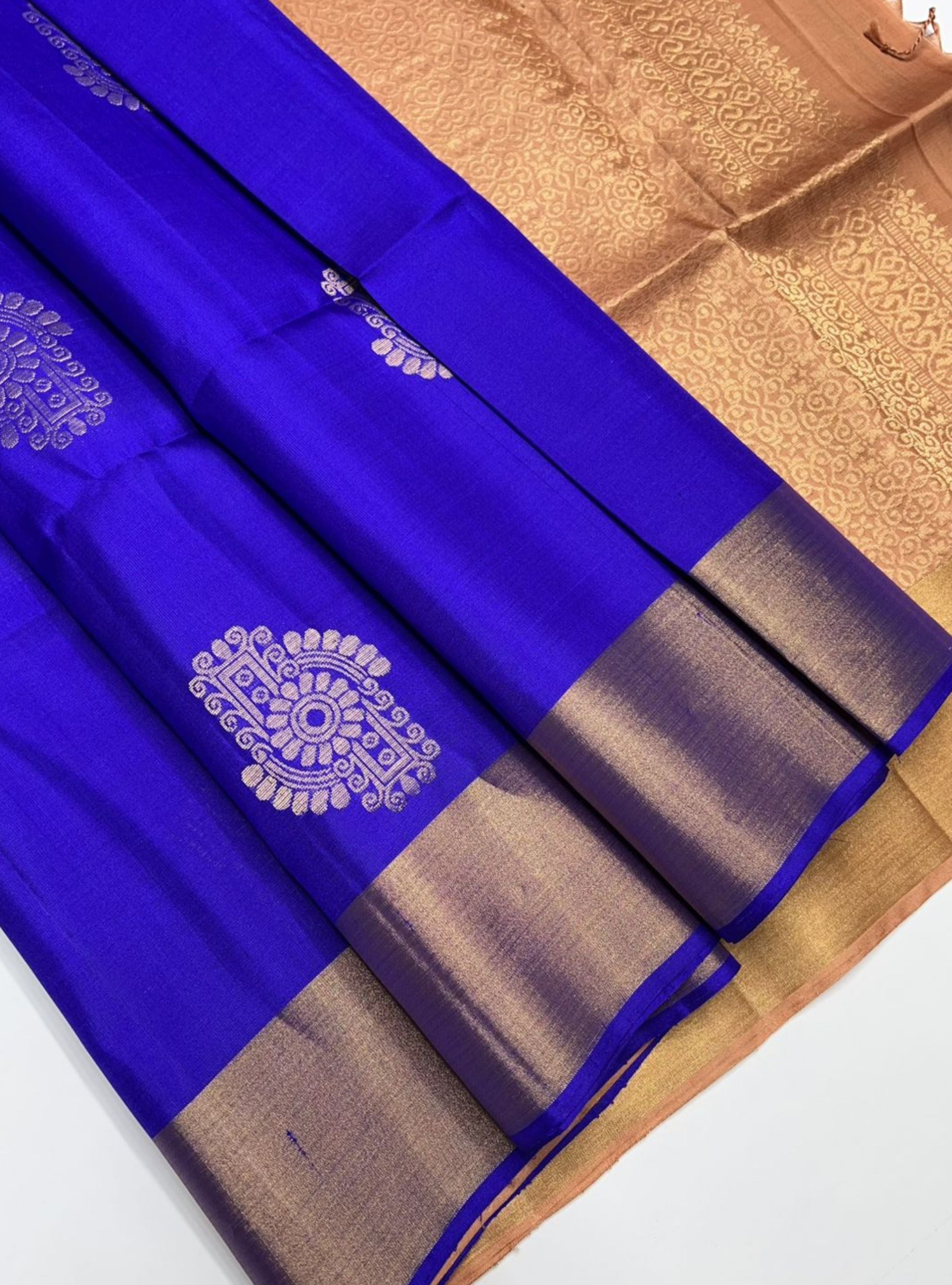 Blue and brown saree with intricate patterns on a white background
