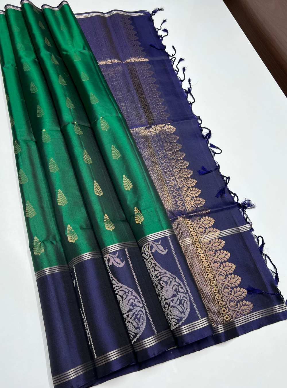 Bottle Green and Navy Soft Silk Saree with fancy design and gold zari motifs, festive wear.