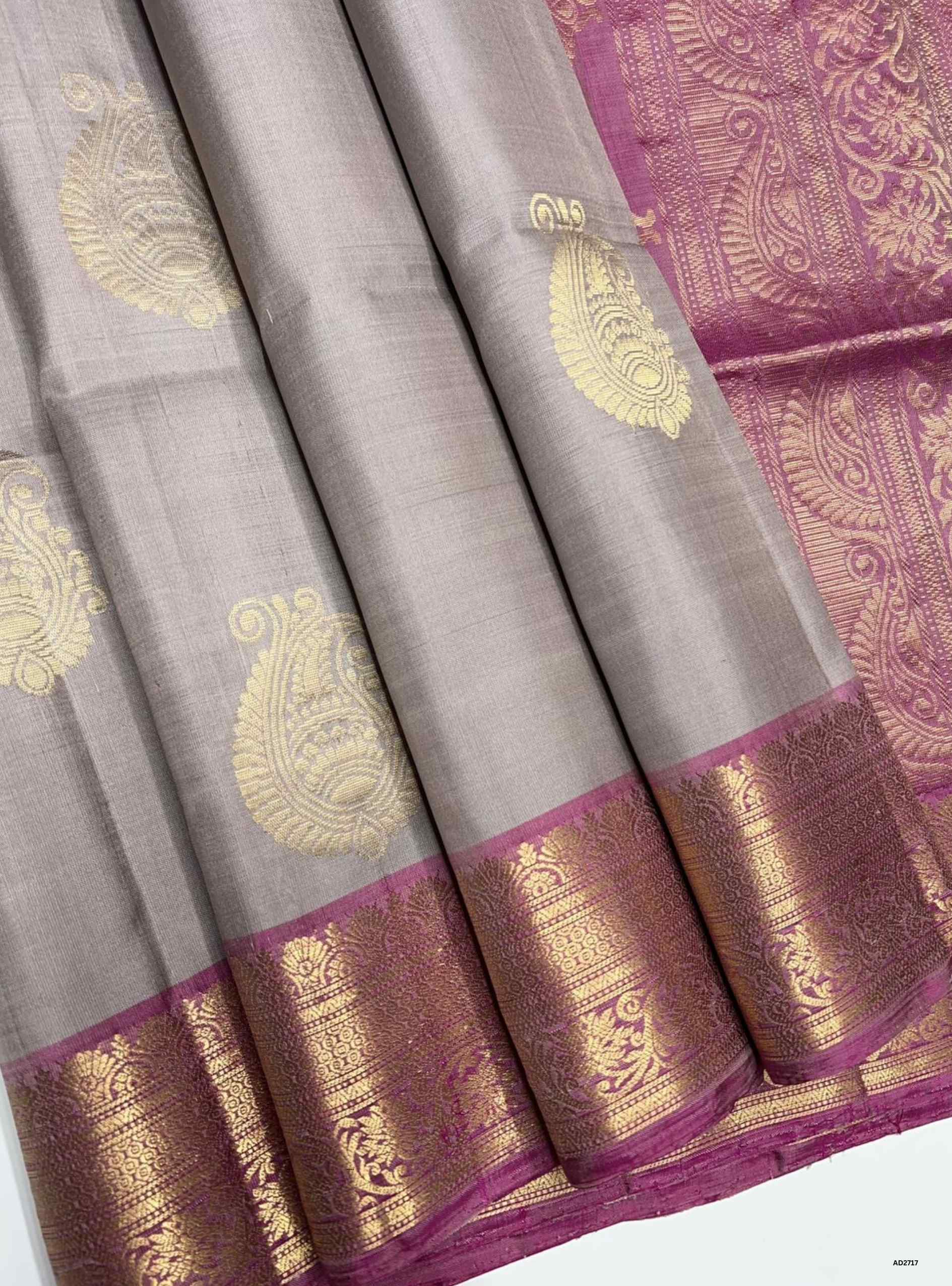 Creamy Grey and Pink Jacquard Border Soft Silk Saree with gold zari motifs.