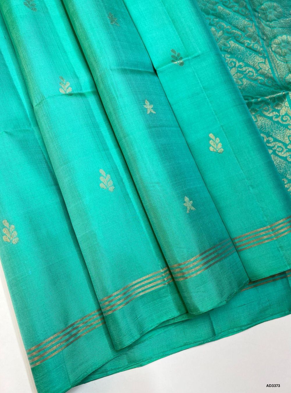 "Handwoven Aqua Blue body Bhutta Soft Silk Saree featuring gold zari motifs and borders"