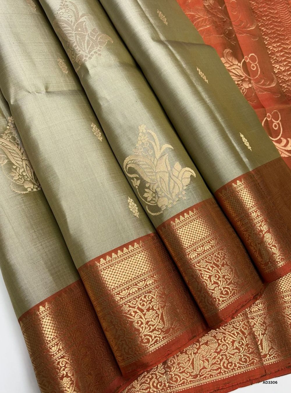 "Handwoven Beige body with Burnt Orange pallu Bhutta Jacquard Border Soft Silk Saree featuring gold zari motifs and borders"