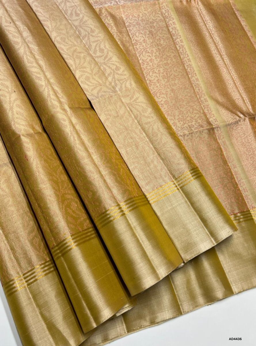 The Beige Soft Silk Bridal Saree with Half Fine Tested Gold Zari is a timeless handwoven creation that radiates purity, grace, and regal charm, making it ideal for weddings, receptions, and auspicious occasions.