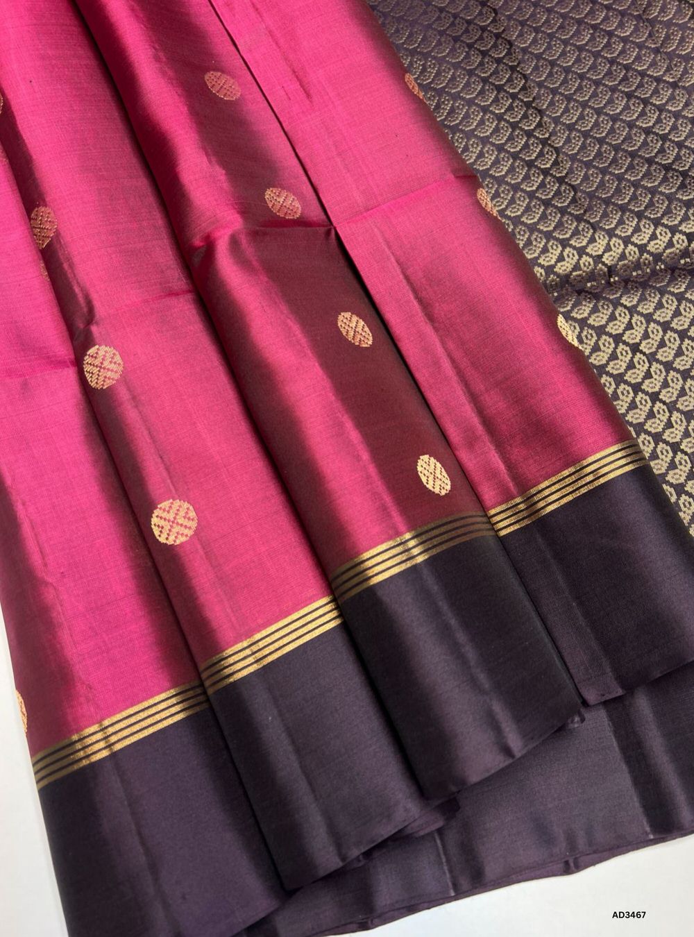 The Berry & Dark Plum Soft Silk Saree is a striking handwoven creation featuring traditional bhutta motifs across its body. The lively berry base is beautifully contrasted with deep dark plum bhutta highlights, while zari accents add a touch of brilliance. Perfect for weddings, festive occasions, and cultural gatherings, this saree blends heritage weaving with timeless elegance.