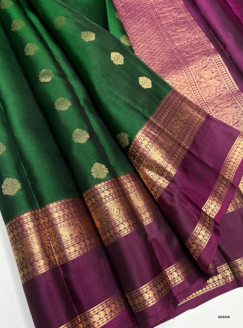"Handwoven Bottle Green body with Dark Magenta pallu Bhutta Jacquard Border Soft Silk Saree featuring gold zari motifs and borders"