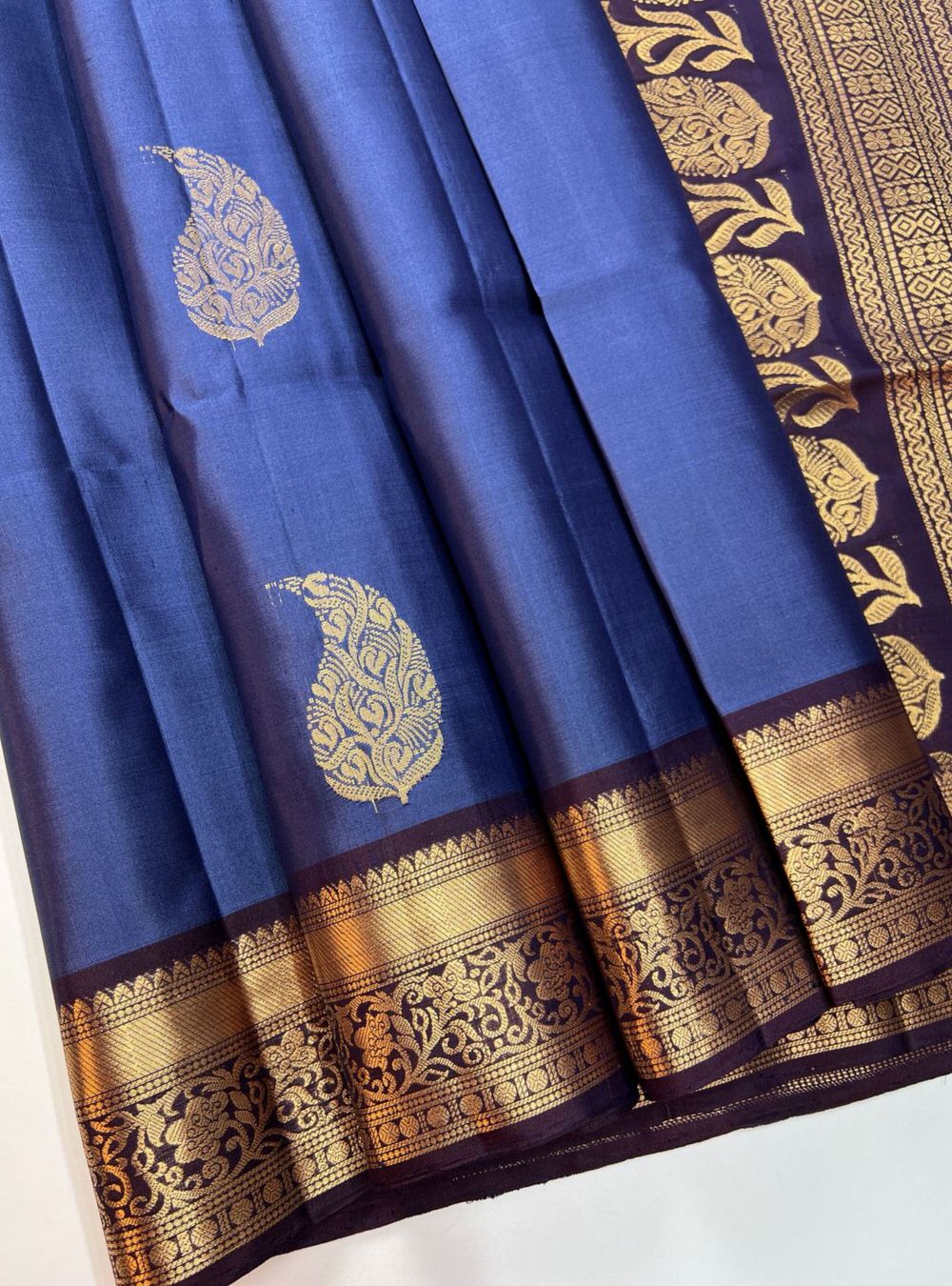 "Handwoven Cobalt Blue body with Coffee Brown pallu Bhutta Jacquard Border Soft Silk Saree featuring gold zari motifs and borders"