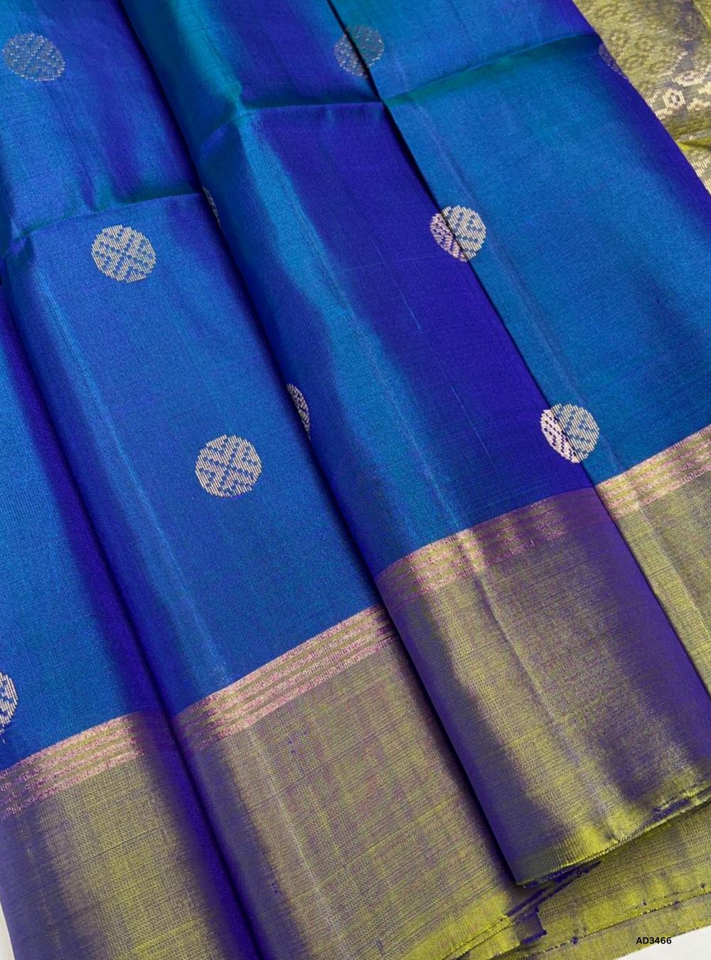 The Cobalt Blue & Dual Tone Green Soft Silk Saree is a striking handwoven creation featuring traditional bhutta motifs across its body. The regal cobalt blue base is beautifully contrasted with dual tone green bhutta highlights, while zari accents add a touch of brilliance. Perfect for weddings, festive occasions, and cultural gatherings, this saree blends heritage weaving with timeless elegance.
