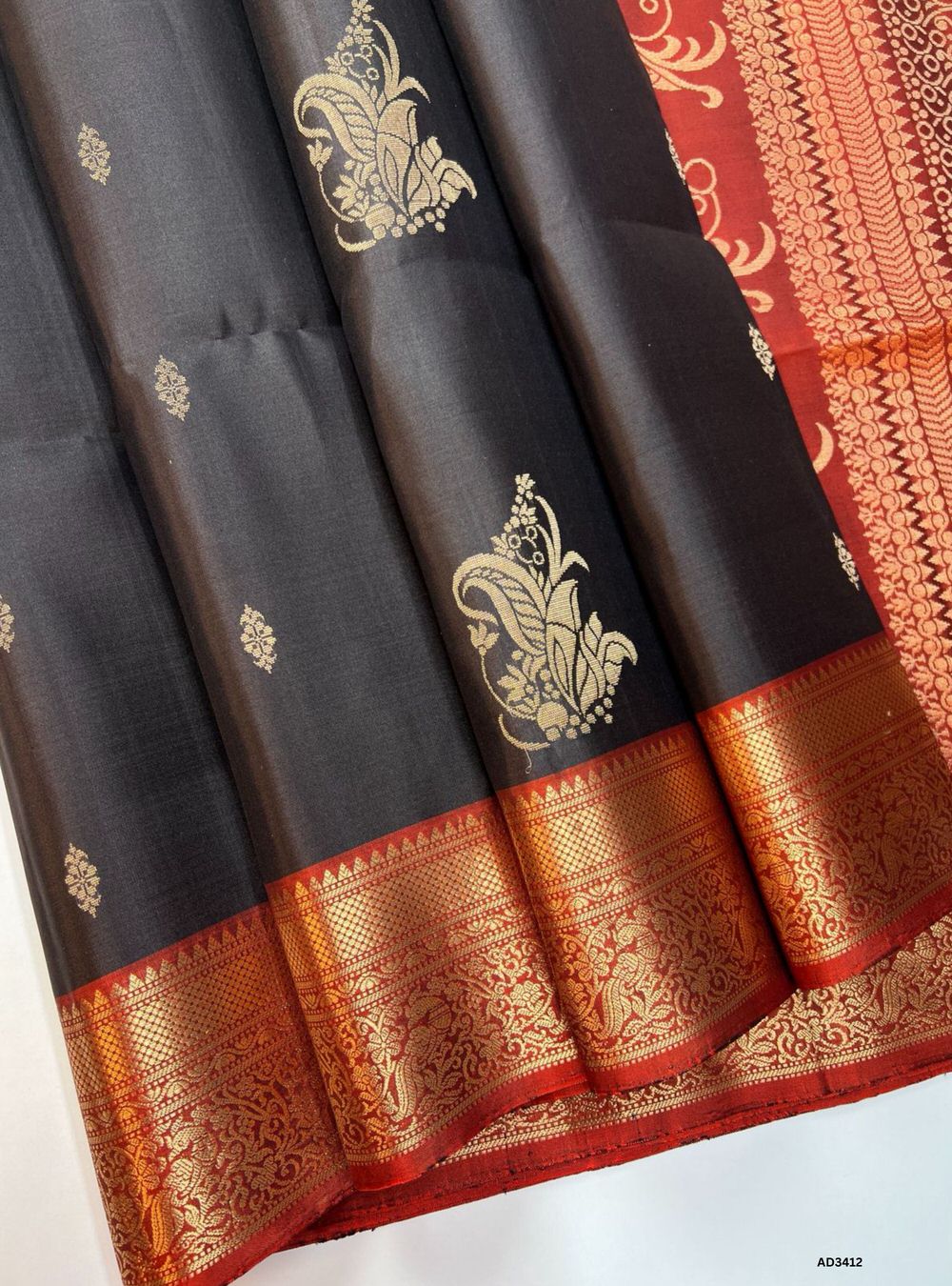 "Handwoven Coffee Bean body with Rust Orange pallu Bhutta Soft Silk Saree featuring gold zari motifs and borders"