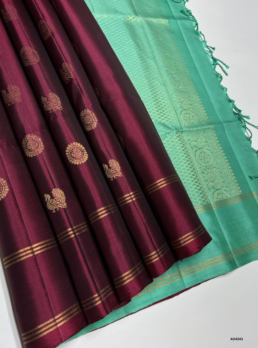 The Coffee Brown & Rama Green Soft Silk Saree with Bhutta motifs is a radiant handwoven creation that embodies festive charm and cultural richness. The coffee brown shade conveys devotion, warmth, and heritage depth, while the Rama green contrast symbolizes prosperity, auspiciousness, and timeless tradition. The bhutta motifs woven across the body enhance its traditional appeal, while zari borders and pallu lend grandeur. Perfect for weddings, temple ceremonies, and festive occasions, this saree reflects So