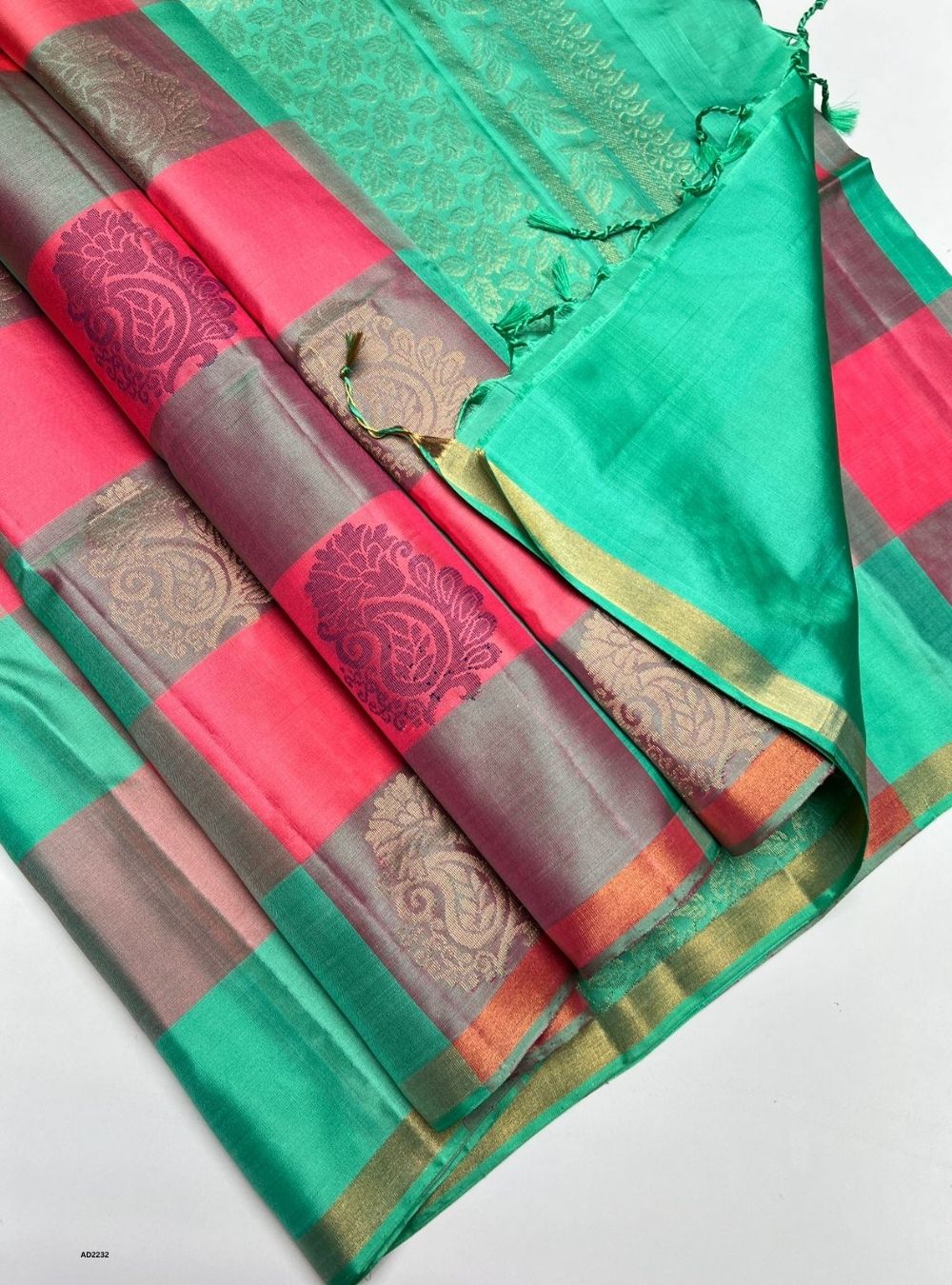 Colorful saree with a patterned border on a white background