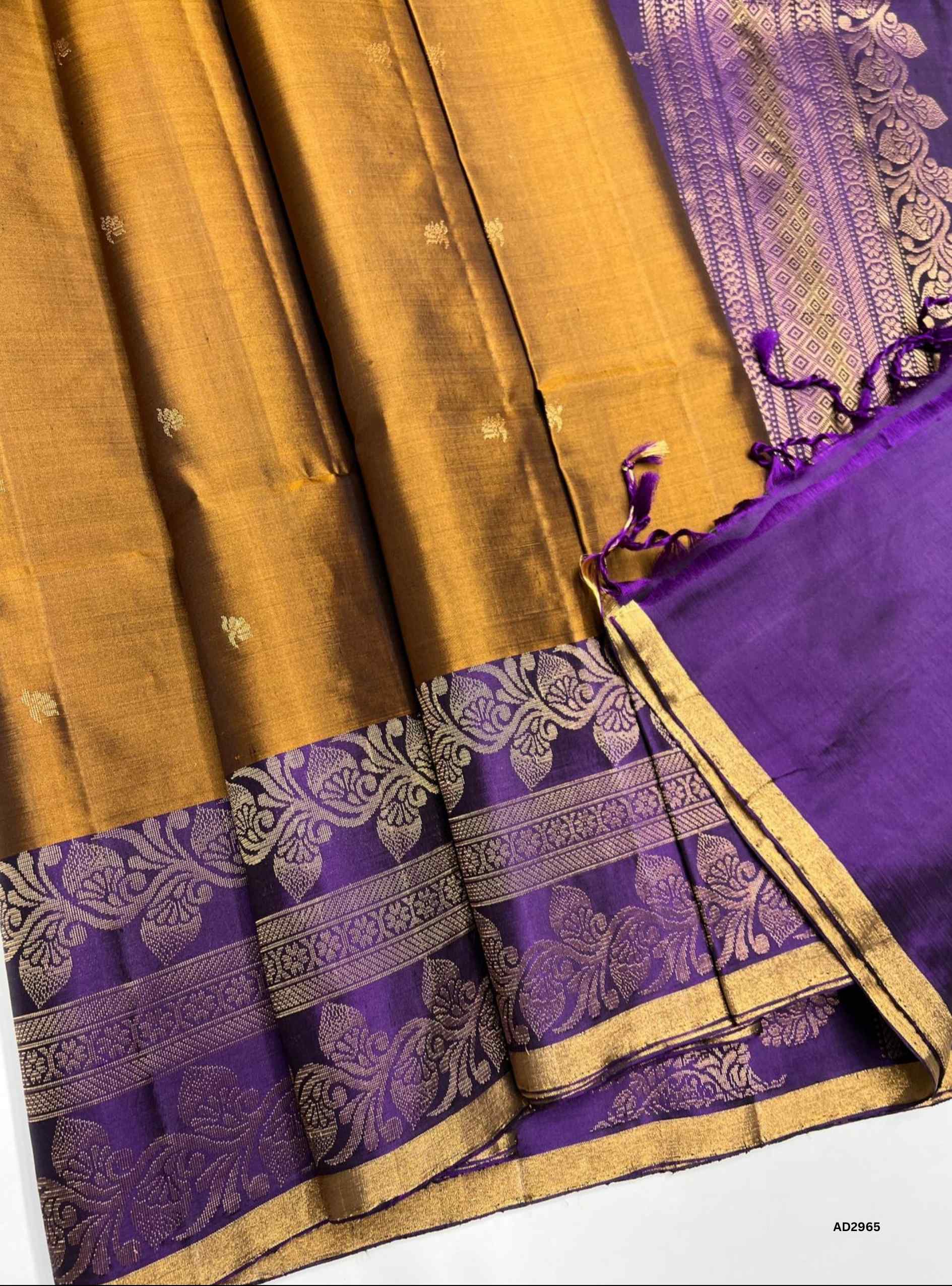 "Handwoven Copper body with Purple pallu Turning Border Soft Silk Saree featuring gold zari motifs"
