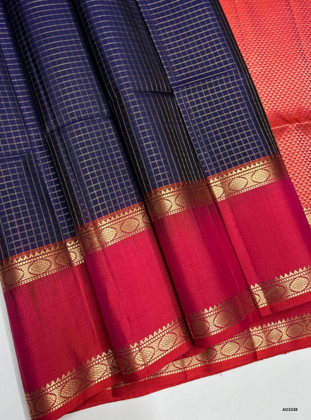 "Handwoven Dark Blue body with Orangish Pink pallu Checkered Soft Silk Saree featuring gold zari motifs and borders"
