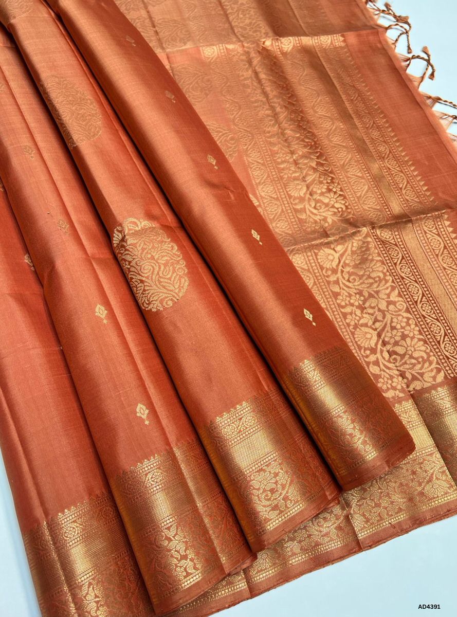 The Dark Coral Kanchi Border Soft Silk Saree is a radiant handwoven creation that embodies festive charm and cultural richness. The dark coral shade conveys warmth, celebration, and feminine elegance, while the temple‑inspired Kanchi border enriched with pure gold zari elevates its grandeur. With its lustrous drape and coordinated blouse, this saree is perfect for weddings, temple ceremonies, and festive occasions. A timeless masterpiece, it blends coral vibrance with the heritage of Kanchipuram weaving.