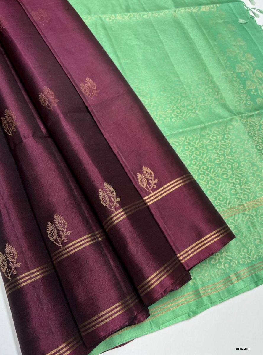 The Deep Wine Bhutta Soft Silk Saree with Pure Gold Zari is a luxurious handwoven creation that radiates regal charm and festive brilliance, making it ideal for weddings, temple ceremonies, and cultural occasions.